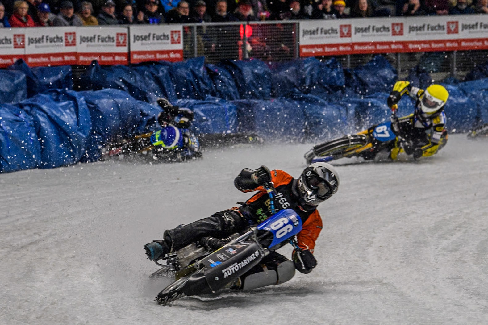 Finland's Aki Ala-Riihimäki (66) (White) leads  as Sweden's Martin Haarahiltunen (199)  (Blue) crashes out during the FIM Ice Speedway Gladiators World Championship Final 2 at the Max-Aicher-Arena, Inzell on Sunday 24 March 2024. (Photo: Ian Charles | MI News)