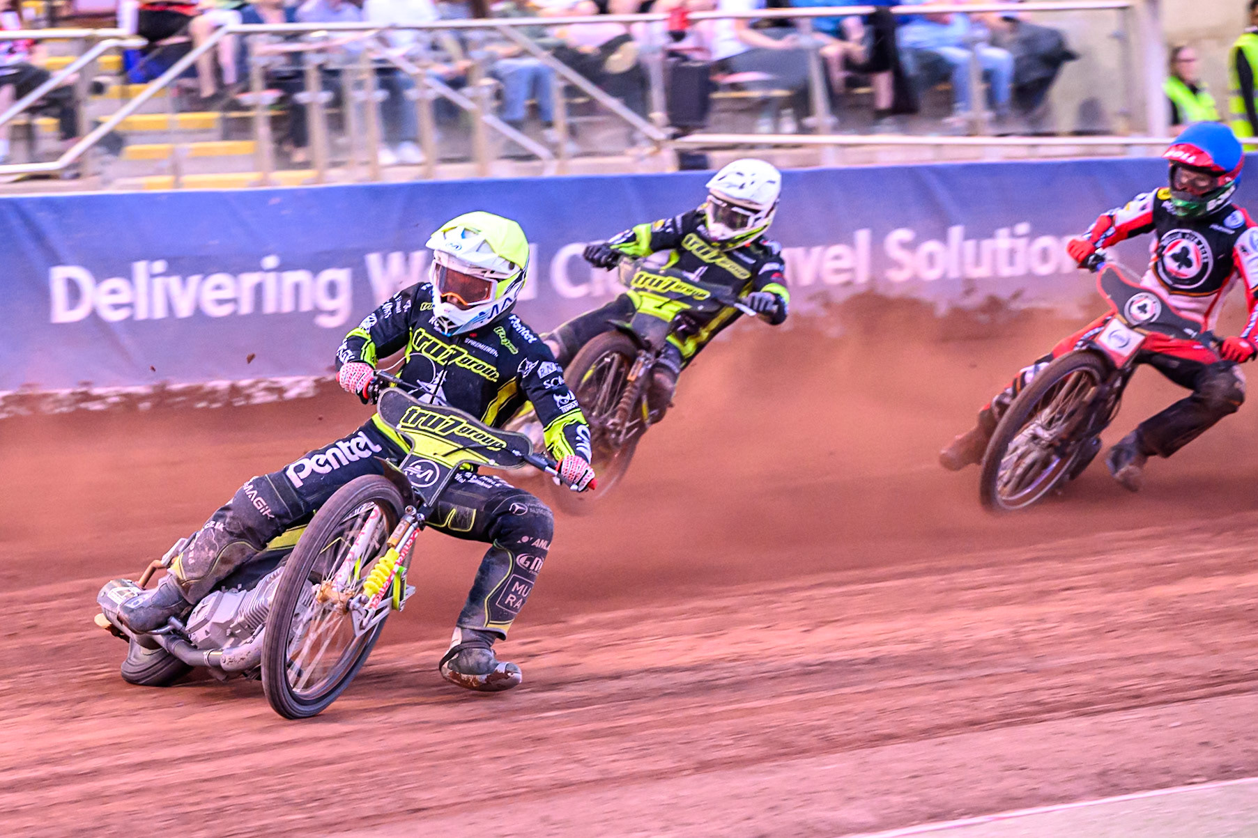 Ipswich Witches' Emil Saifutdinov  in Yellow leading Belle Vue Aces' Brady Kurtz  in Blue and Ipswich Witches' Tom Brennan  in White during the Rowe Motor Oil Premiership match between Belle Vue Aces and Ipswich Witches at the National Speedway Stadium, Manchester on Monday 30th June 2025. (Photo: Ian Charles | MI News)
