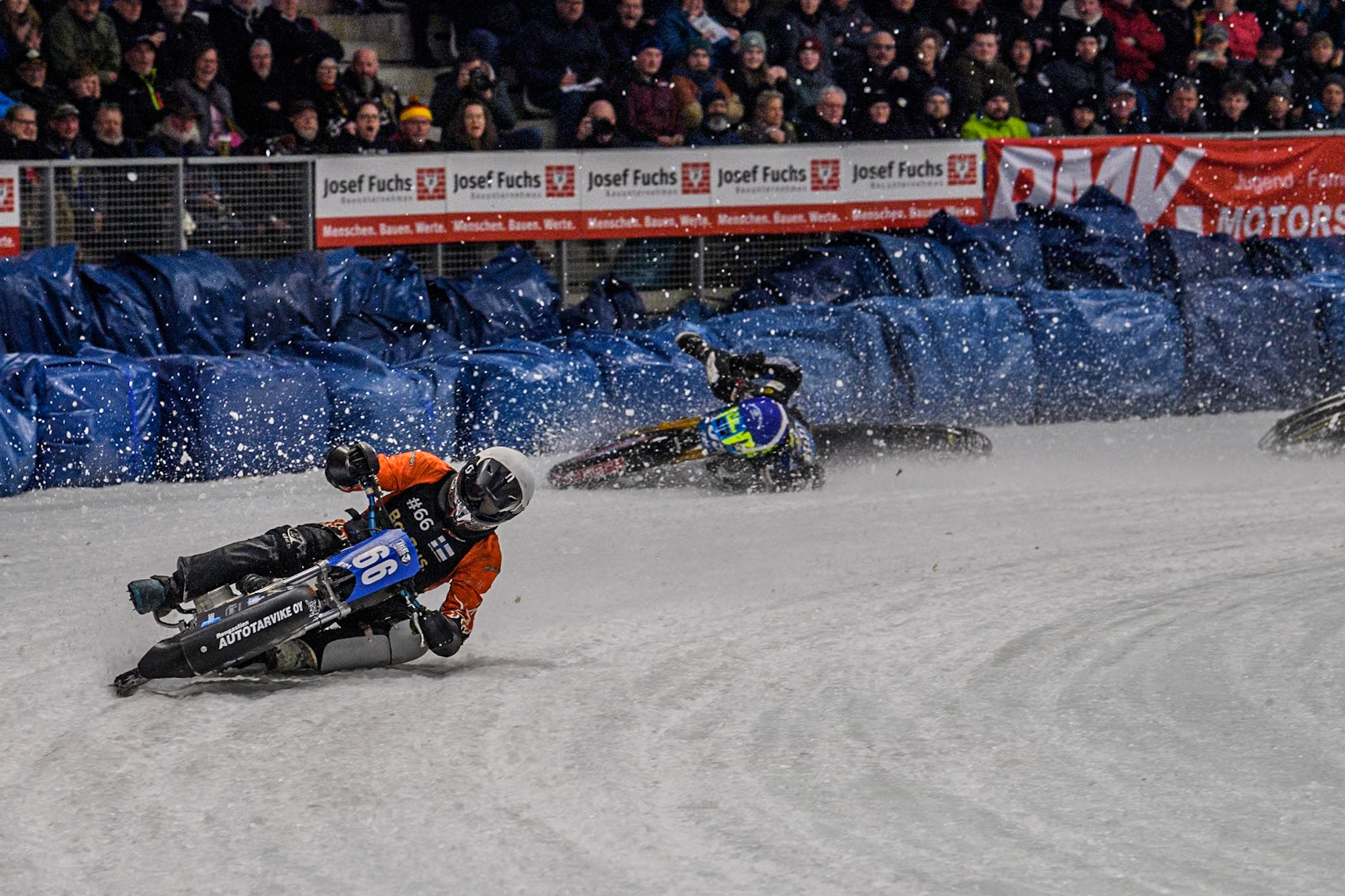 Finland's Aki Ala-Riihimäki (66) (White) leads  as Sweden's Martin Haarahiltunen (199)  (Blue) crashes out during the FIM Ice Speedway Gladiators World Championship Final 2 at the Max-Aicher-Arena, Inzell on Sunday 24 March 2024. (Photo: Ian Charles | MI News)