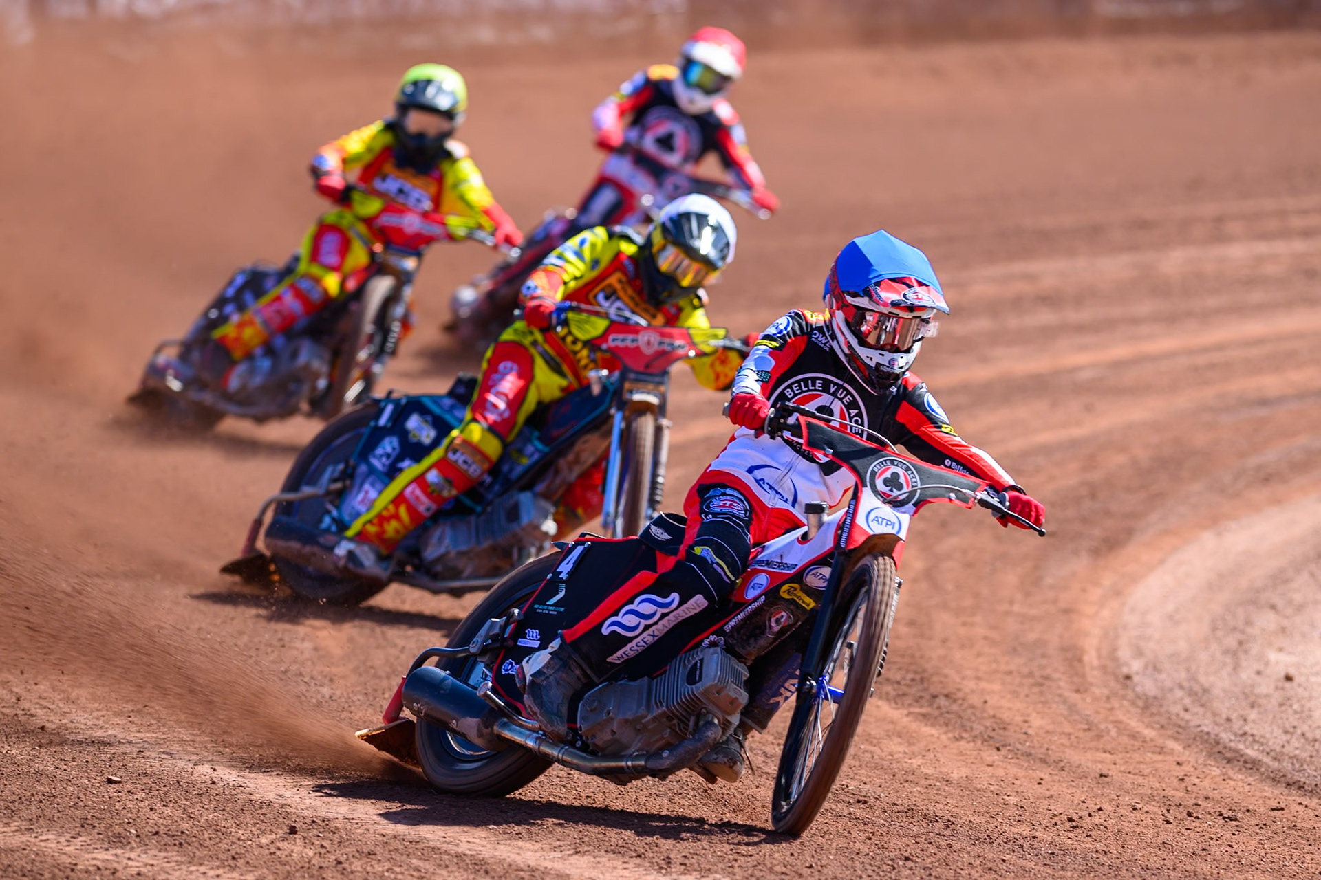 Zach Cook of Belle Vue Aces  in Blue leading Ryan Douglas of Leicester Lions  in White, Dan Thompson of Leicester Lions  in Yellow and Peter Kildemand of Belle Vue Aces  in Red during the Knockout Cup Northern Section match between Belle Vue Aces and Leicester Lions at the National Speedway Stadium, Manchester on Monday 6th April 2026. (Photo: Ian Charles | MI News)