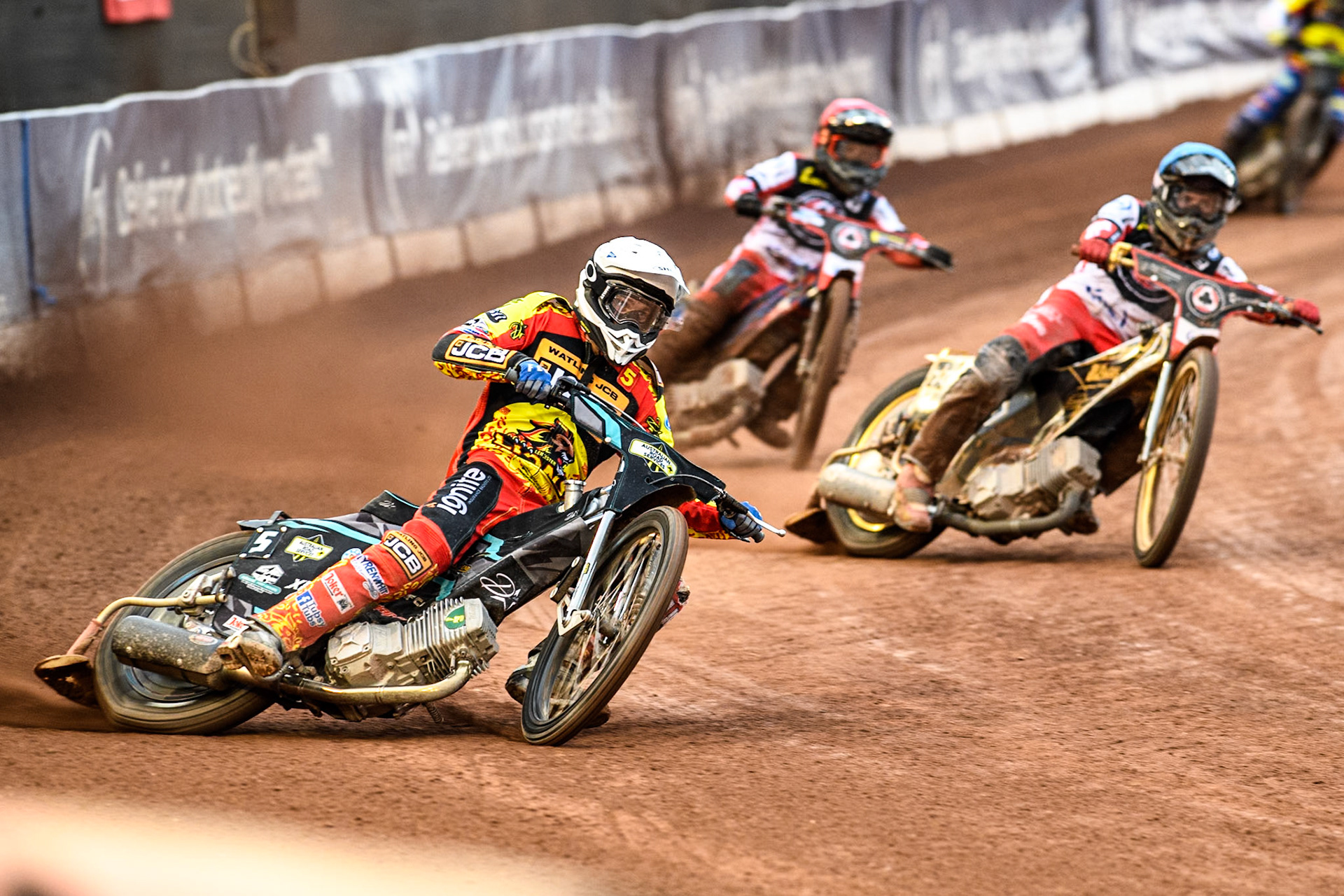 Leicester Lions' Max Fricke in White leading Belle Vue Aces' Norick Blodorn in Blue and Belle Vue Aces' Ben Cook in Red during the Rowe Motor Oil Premiership match between Belle Vue Aces and Leicester Lions at the National Speedway Stadium, Manchester on Monday 24th June 2024. (Photo: Ian Charles | MI News)