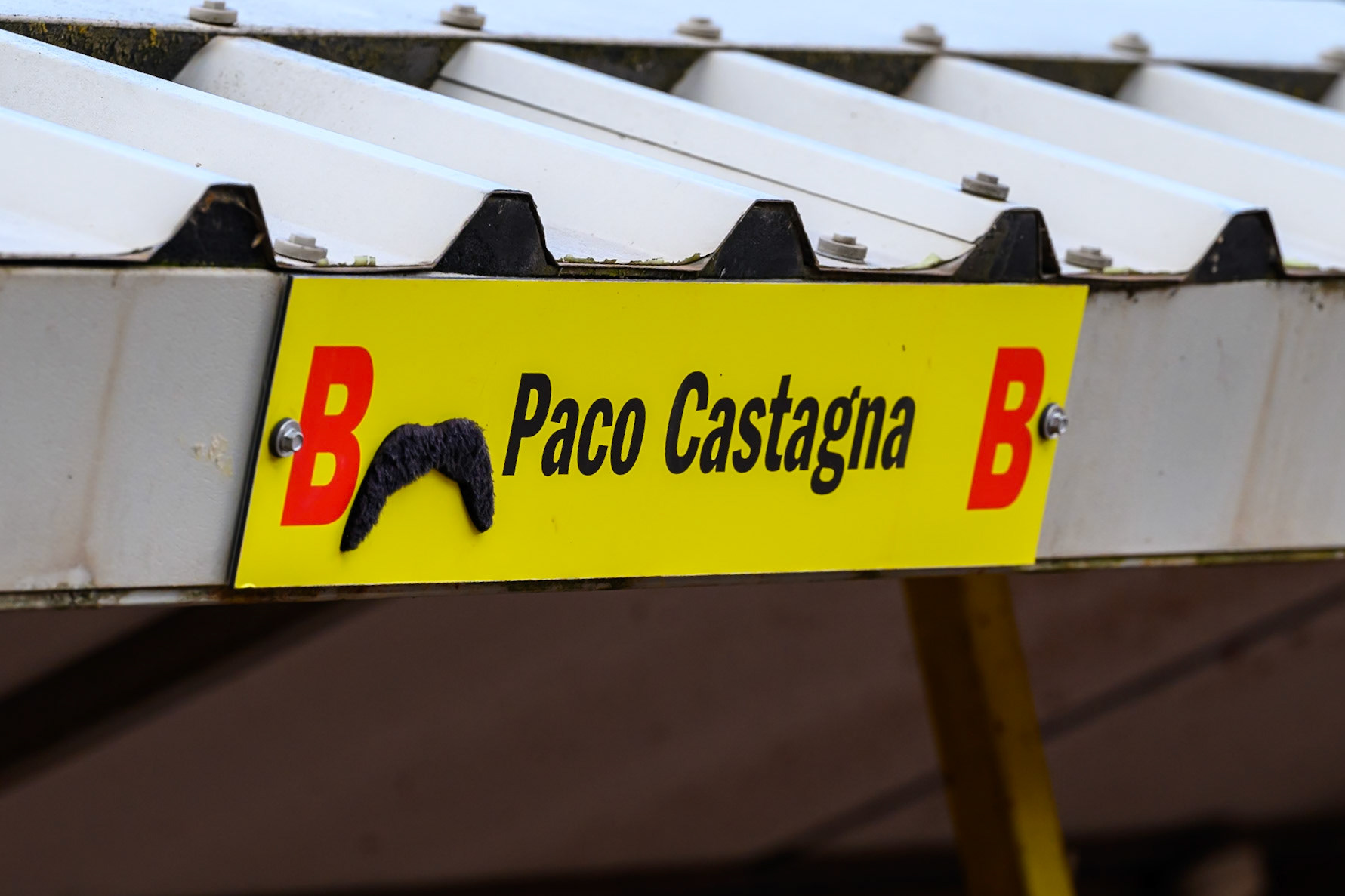 The sign above the pit bay for Paco Castagna with his “trademark” moustache during the Rowe Motor Oil Premiership match between Birmingham Brummies and Belle Vue Aces at Perry Barr Stadium, Birmingham on Monday 28th July 2025. (Photo: Ian Charles | MI News)
