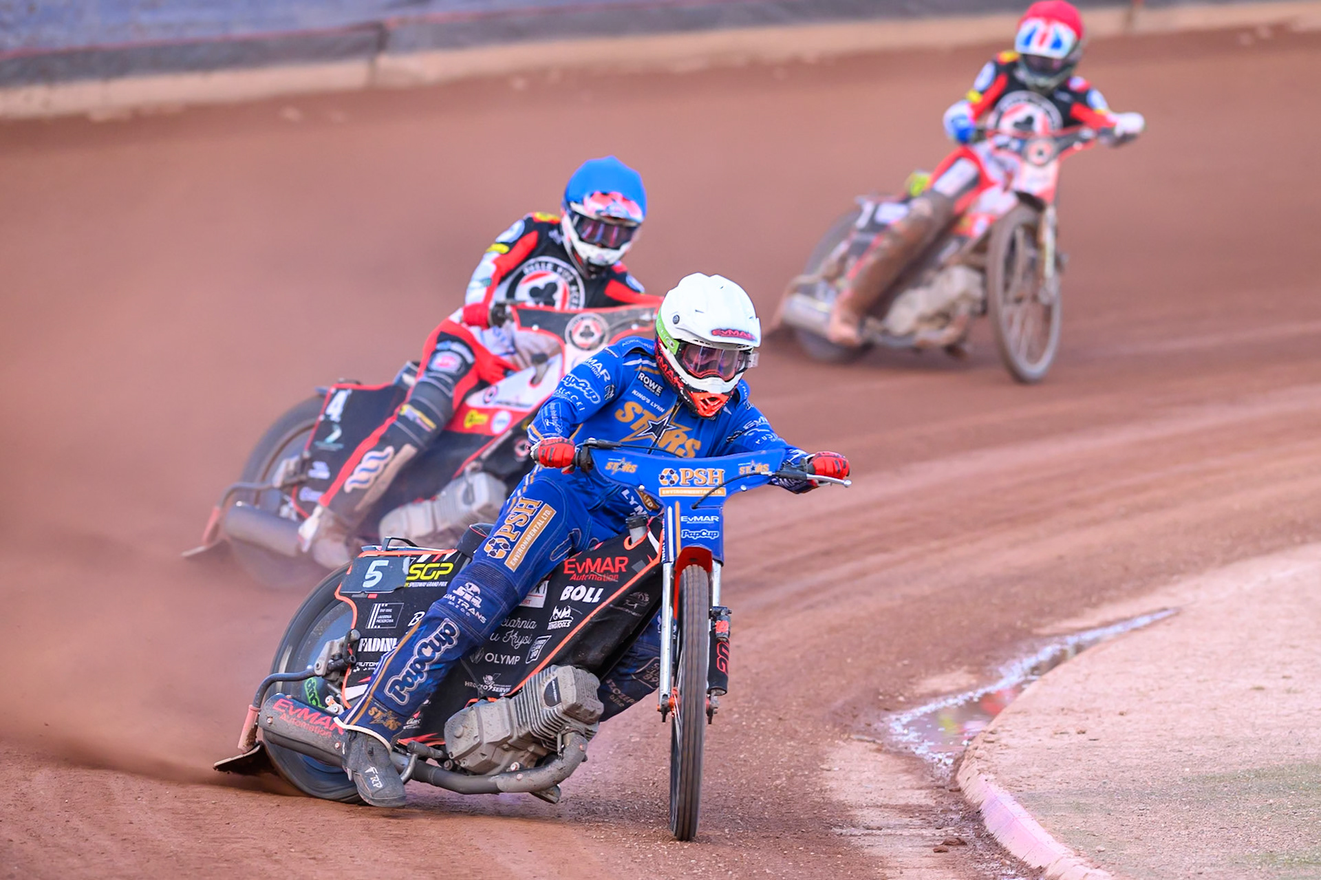 Jan Kvech of Kings Lynn Stars leading Zach Cook of Belle Vue Aces in Blue and Norick Blödorn of Belle Vue Aces in Red during the Rowe Motor Oil Premiership match between Belle Vue Aces and King's Lynn Stars at the National Speedway Stadium, Manchester on Monday 10th August 2026. (Photo: Ian Charles | MI News)