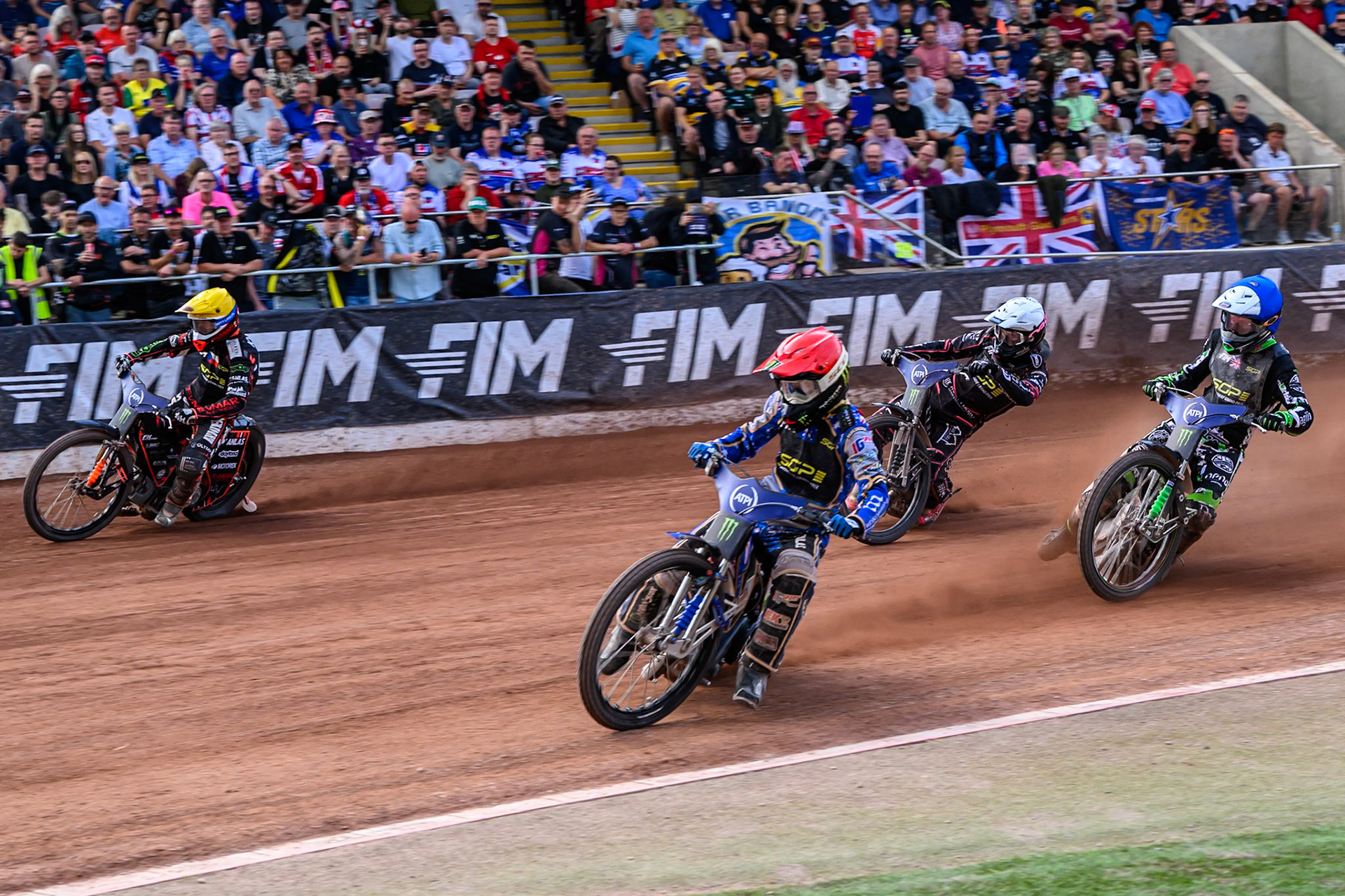 Jack Holder (25) of Australia in Red rides inside 201\ in Yellow, with Wild Card Charles Wright (16) of Great Britain in Blue and 744\ in White behind during the ATPI FIM Speedway Grand Prix Round 4 at the National Speedway Stadium, Manchester, on Friday 13th June 2025. (Photo: Ian Charles | MI News)