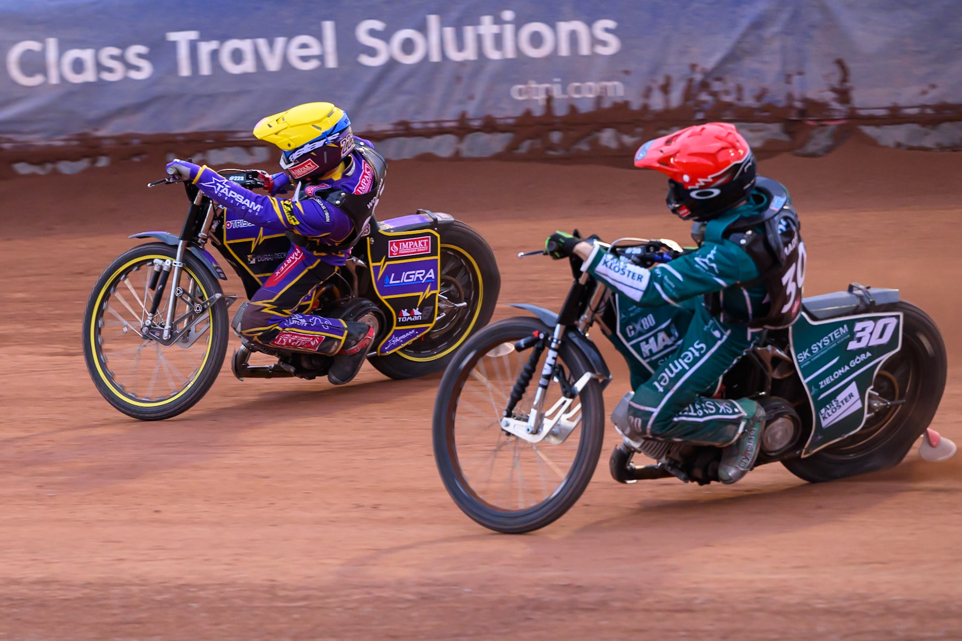 Leon Madsen (30) of Denmark in Red chases Kacper Woryna (223) of Poland in Yellow during the ATPI  FIM Speedway GP of Manchester at the National Speedway Stadium, Manchester on Friday 5th June 2026. (Photo: Ian Charles | MI News)