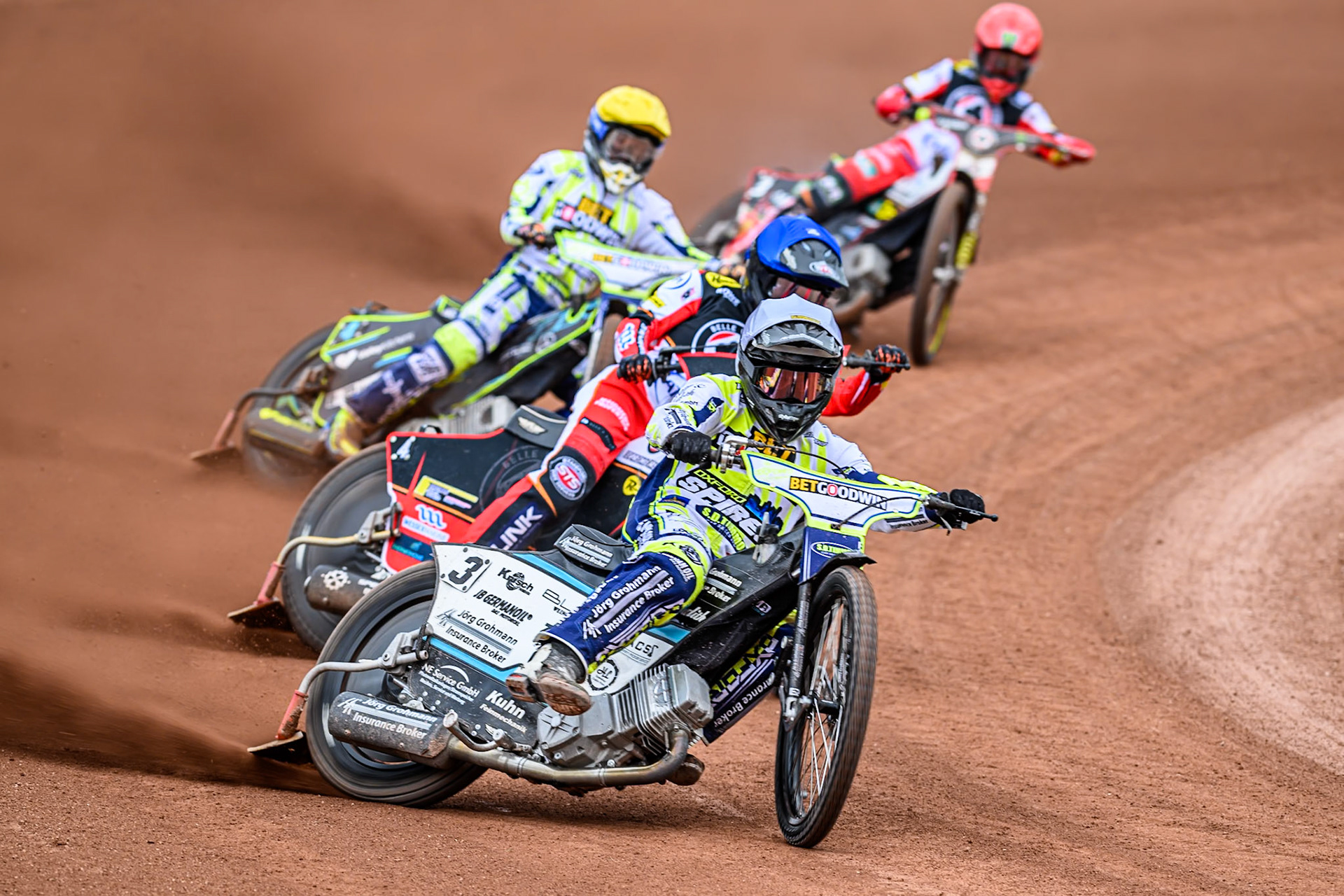 Oxford Spires' Erik Riss in White leading Belle Vue Aces' Zach Cook in Blue, Oxford Spires' Rohan Tungate in Yellow and Belle Vue Aces' Jaimon Lidsey in Red during the Rowe Motor Oil Premiership match between Belle Vue Aces and Oxford Spires at the National Speedway Stadium, Manchester on Monday 26th May 2025. (Photo: Ian Charles | MI News)