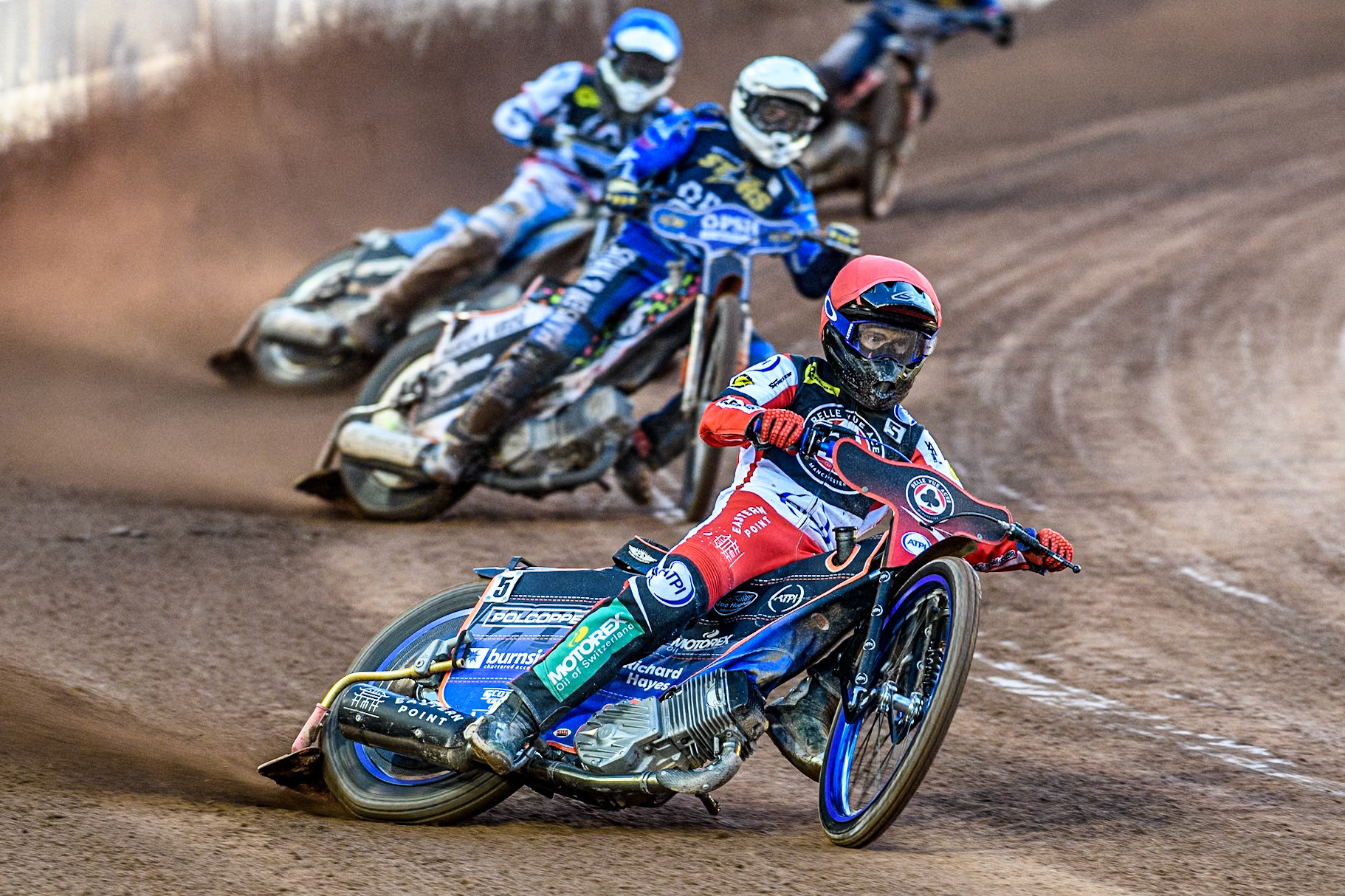 Belle Vue Aces' Brady Kurtz  in Red leading Kings Lynn Stars' Niels-Kristian Iversen  in White and Belle Vue Aces' Antti Vuolas  in Blue during the Rowe Motor Oil Premiership match between Belle Vue Aces and King's Lynn Stars at the National Speedway Stadium, Manchester on Monday 12th August 2024. (Photo: Ian Charles | MI News)