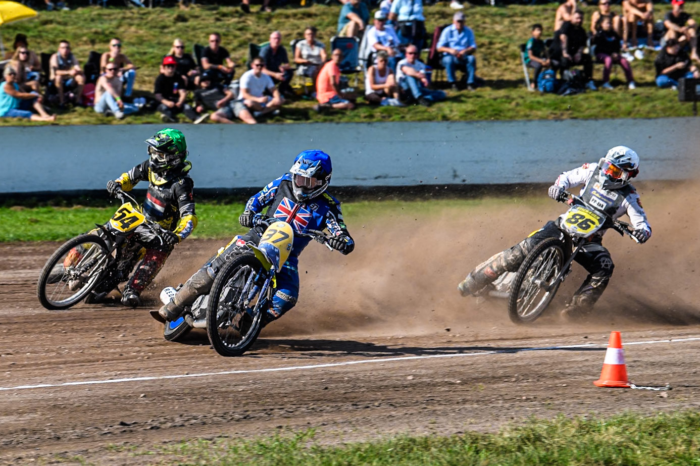 Chris Harris (37)of Great Britain in Blue rides inside Mika Meijer (54) of The Netherlands in Green  with Hynek Stichauer (86) of Czech Republic  in White behind during the FIM Long Track World Championship Final 5 at the Speed Centre Roden, Roden, Netherlands on Sunday 22nd September 2024. (Photo: Ian Charles | MI News)