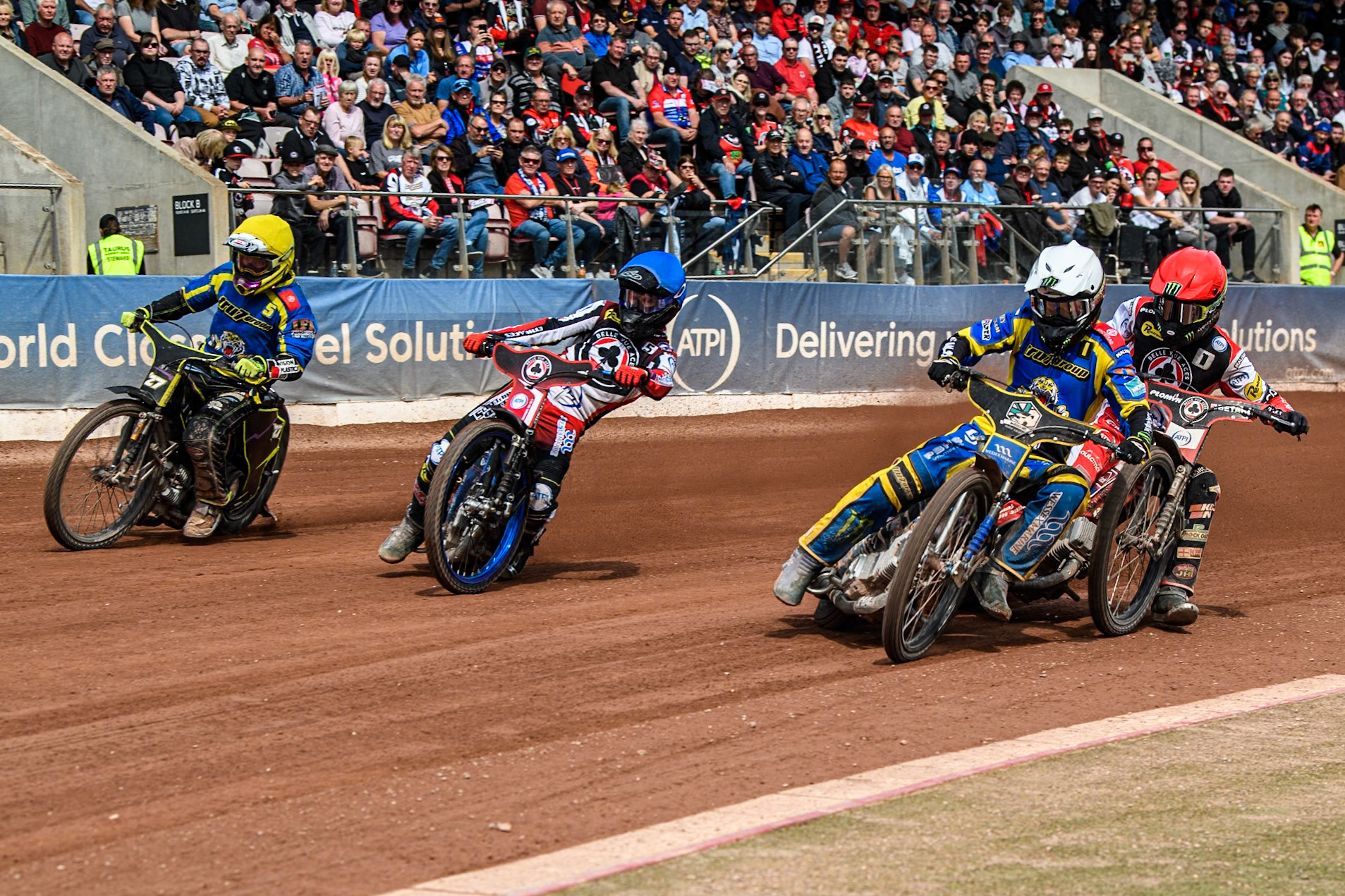 Sheffield Tigers' Jack Holder  in White shuts down Belle Vue Aces' Dan Bewley   in Red with Belle Vue Aces' Brady Kurtz  in Blue and Sheffield Tigers' Guest Rider Tom Brennan  in Yellow on the outside during the Rowe Motor Oil Premiership match between Belle Vue Aces and Sheffield Tigers at the National Speedway Stadium, Manchester on Monday 26th August 2024. (Photo: Ian Charles | MI News)