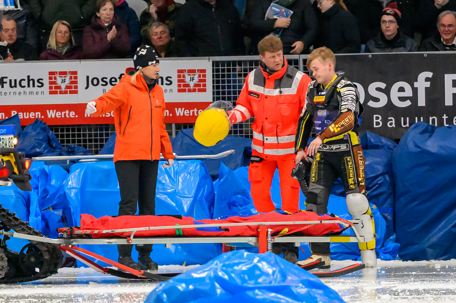 Heikki Huusko (67) of Finland  is helped onto the medical transport after his first bend crash during the Ice Speedway Gladiators World Championship Final 2 at Max-Aicher-Arena, Inzell on Sunday 15th March 2026. (Photo: Ian Charles | MI News)