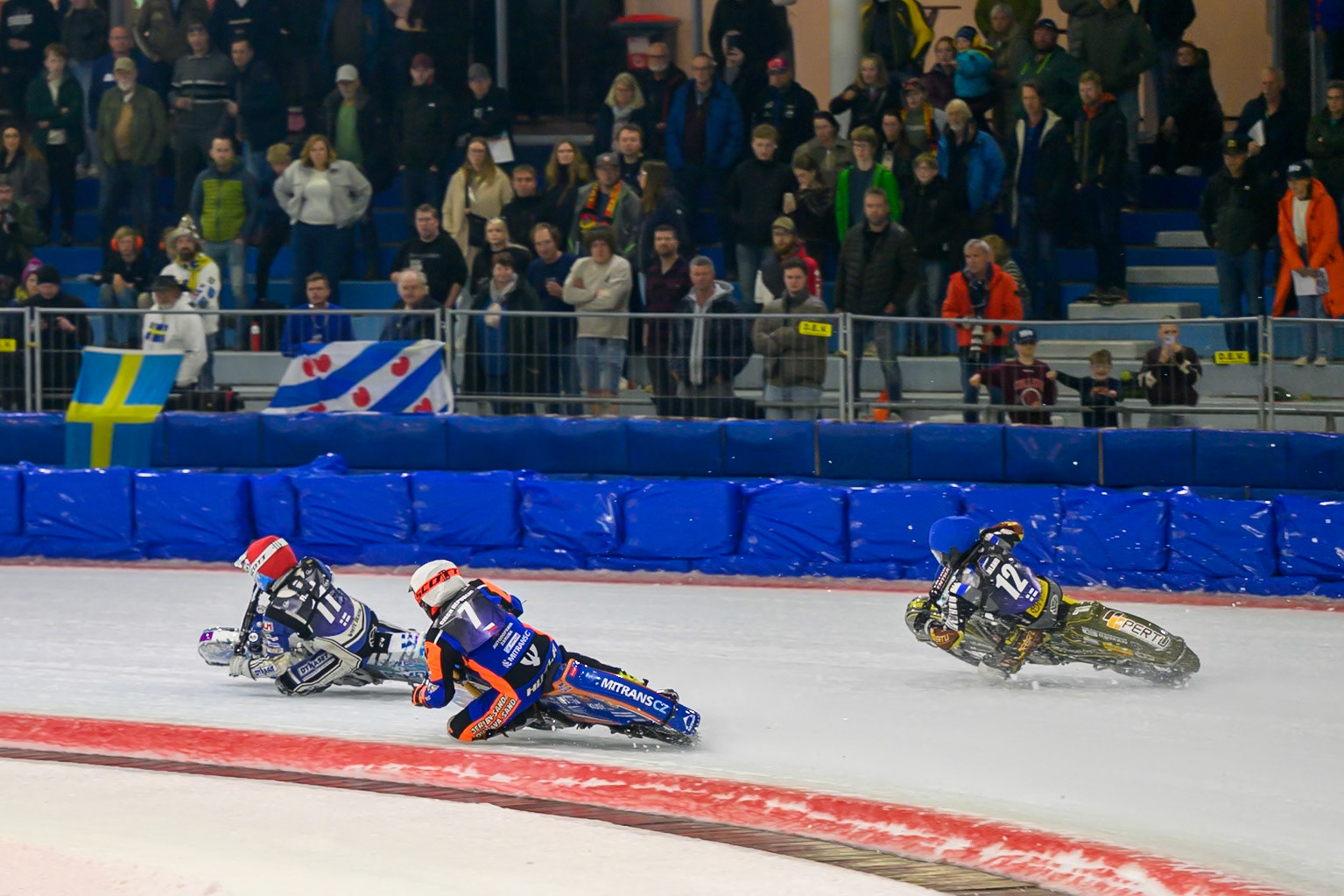 Lukáš Hutla (7) of Czechia  in White rides inside Heikki Huusko (12) of Finland  in Blue with Max Koivula (11) of Finland  in Red ahead during the FIM Ice Speedway Of Nations at Ice Rink Thialf, Heerenveen on Sunday 12th April 2026. (Photo: Ian Charles | MI News)