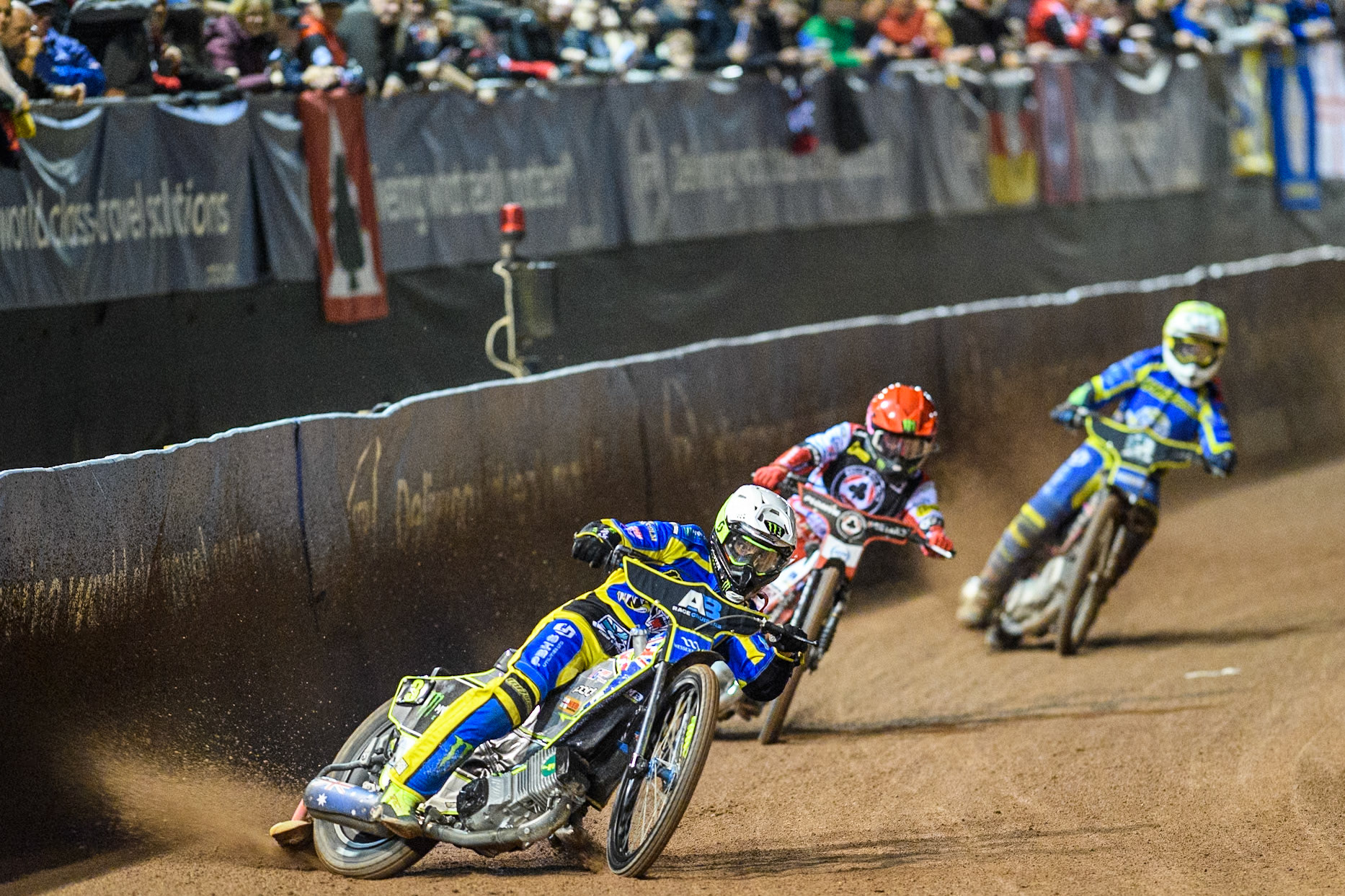 Sheffield Tigers' Chris Holder  in White leading Belle Vue Aces' Dan Bewley  in Red and Sheffield Tigers' Josh Pickering  in Yellow during the Rowe Motor Oil Premiership Play Off Semi Final 2, 1st Leg match between Belle Vue Aces and Sheffield Tigers at the National Speedway Stadium, Manchester on Monday 16th September 2024. (Photo: Ian Charles | MI News)