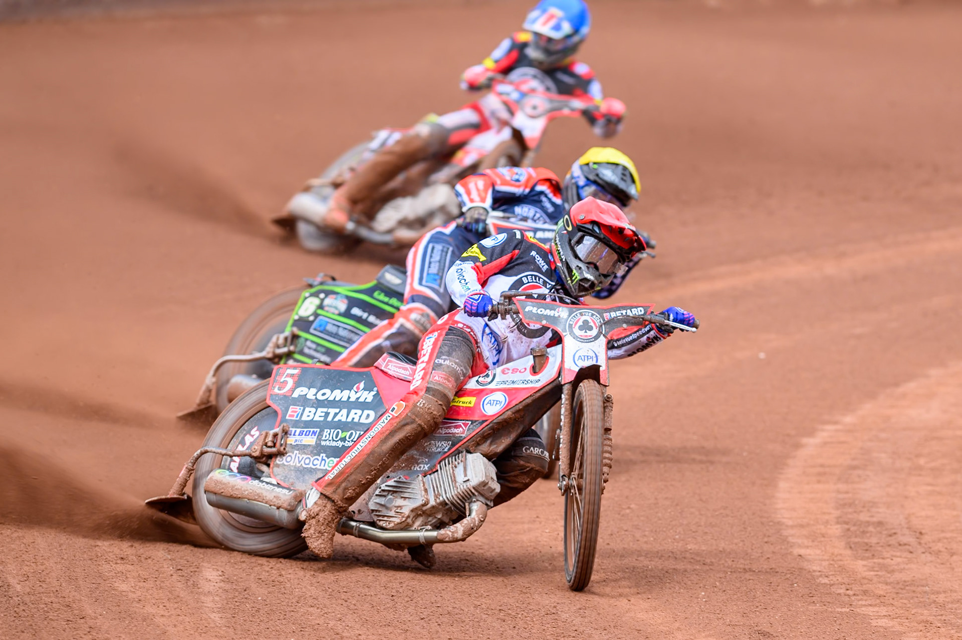 Dan Bewley of Belle Vue Aces in Red leading Kye Thomson of Northampton Foxes in Yellow and Will Cairns of Belle Vue Aces in Blue during the Rowe Motor Oil Premiership match between Belle Vue Aces and Northampton Foxes at the National Speedway Stadium, Manchester on Monday 4th May 2026. (Photo: Ian Charles | MI News)