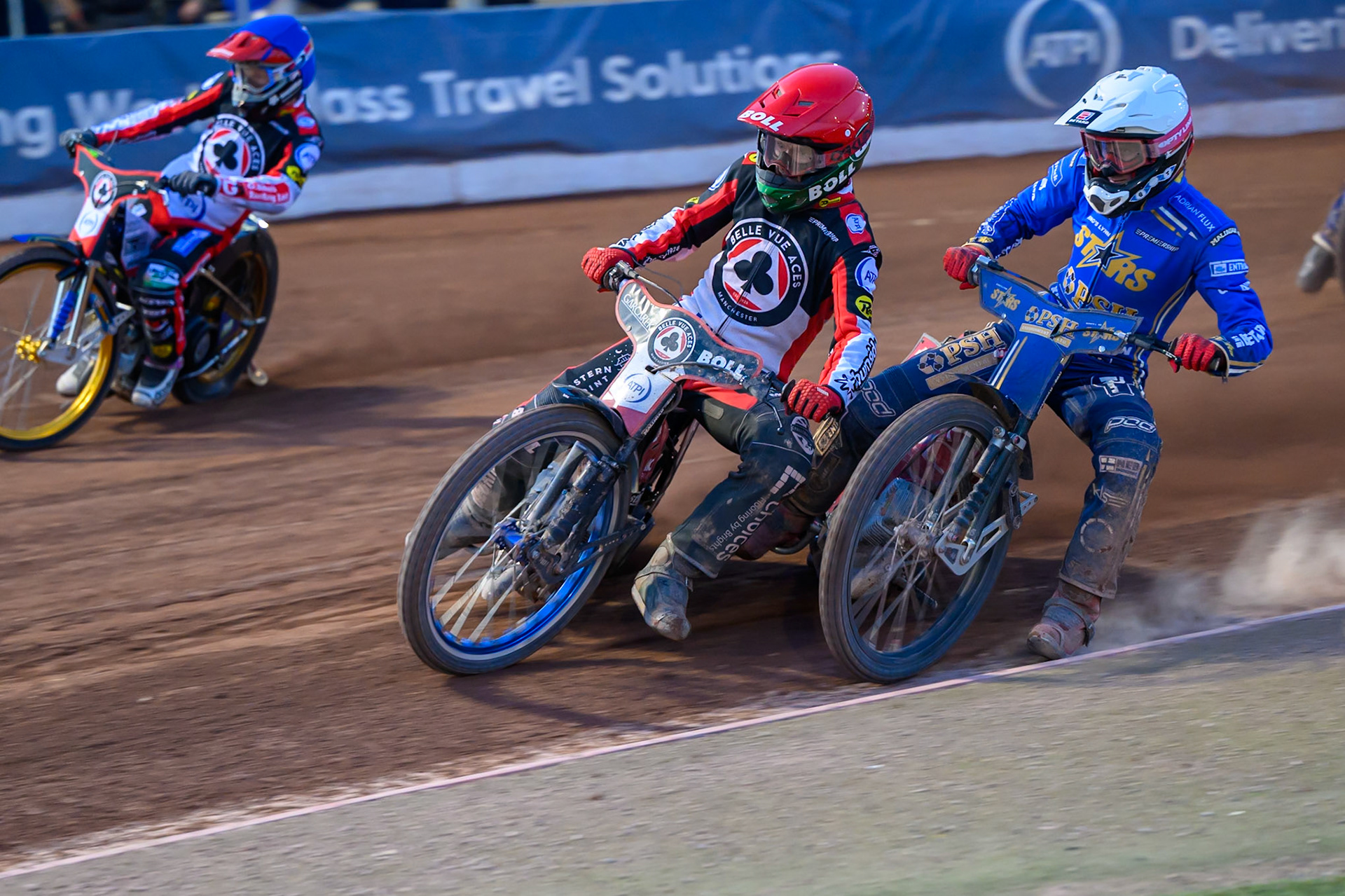 Brady Kurtz of Belle Vue Aces in Red rides outside Max Fricke of Kings Lynn Stars in White with Jason Doyle of Belle Vue Aces on the outside during the Rowe Motor Oil Premiership match between Belle Vue Aces and King's Lynn Stars at the National Speedway Stadium, Manchester on Monday 10th August 2026. (Photo: Ian Charles | MI News)