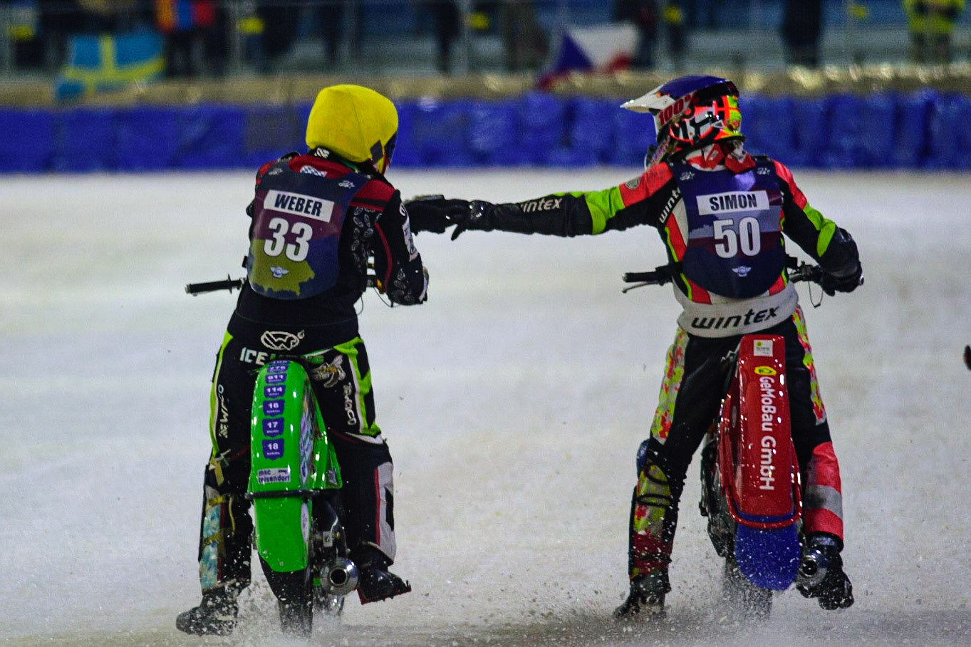 HEERENVEEN, NL.  Johann Weber (33)  congratulates Harald Simon (50) on his win during the FIM Ice Speedway Gladiators World Championship Final 4 at Ice Rink Thialf, Heerenveen on Sunday  3 April 2022. (Credit: Ian Charles | MI News)