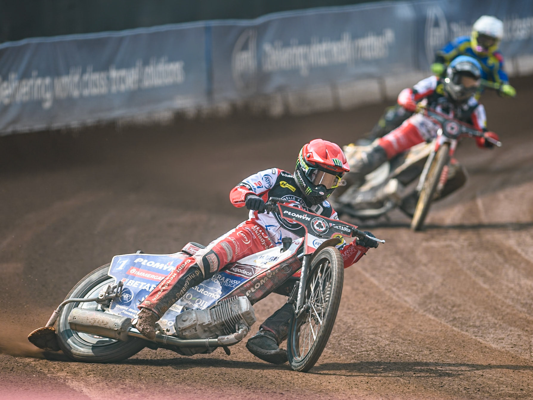 Belle Vue Aces' Dan Bewley   in Red leading Belle Vue Aces' Norick Blödorn  in Blue and Sheffield Tigers' Guest Rider Tom Brennan  in White during the Rowe Motor Oil Premiership match between Belle Vue Aces and Sheffield Tigers at the National Speedway Stadium, Manchester on Monday 26th August 2024. (Photo: Ian Charles | MI News)