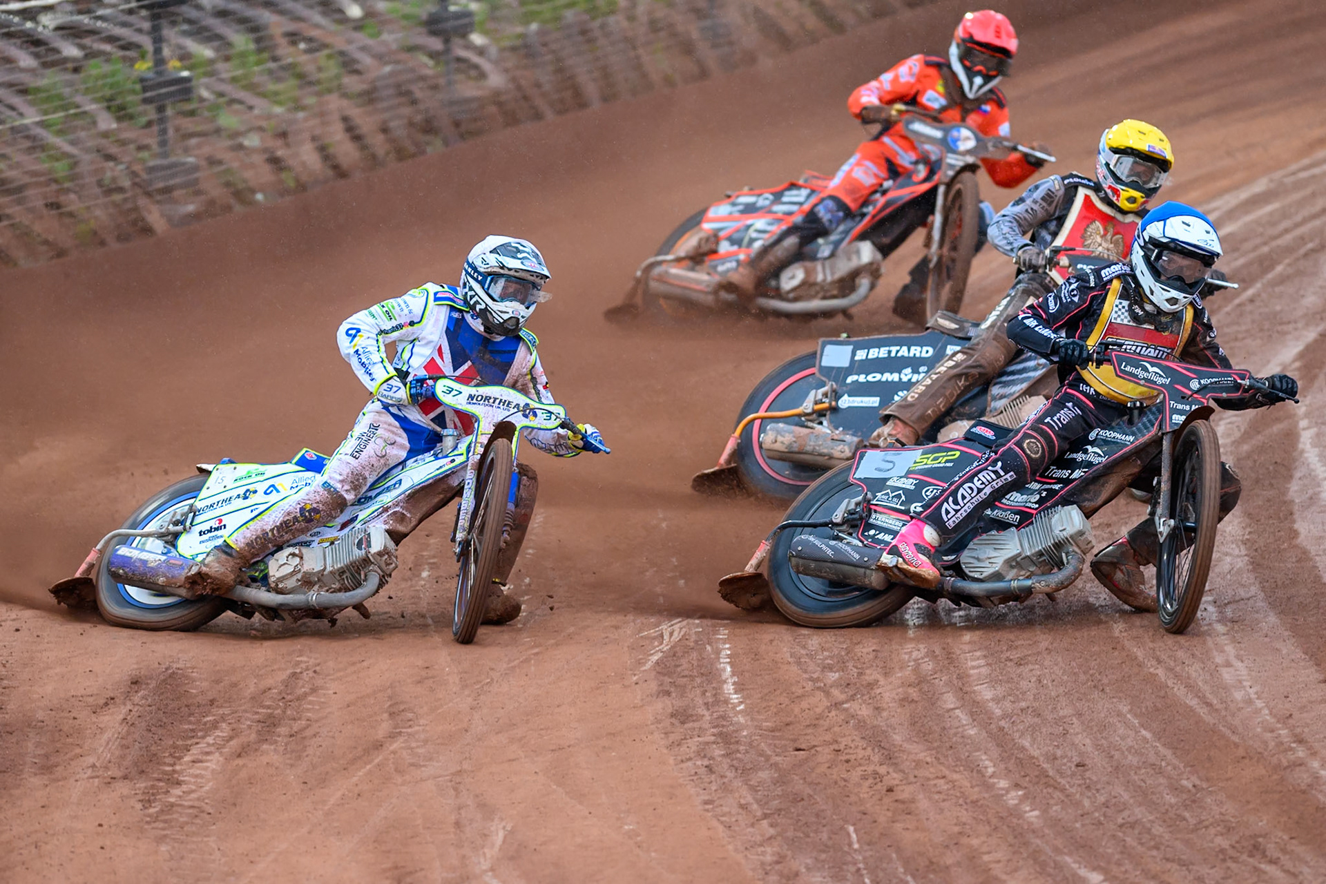 Chris Harris of Great Britain in White rides outside Kai Huckenbeck of Germany in Blue with Maciej Janowski of Poland in Yellow and Sven Cerjak of Slovenia in Red behind during the Speedway GP Qualifying Round 3 at Allied Ashfield Stadium, Glasgow on Saturday 30th May 2026. (Photo: Ian Charles | MI News)