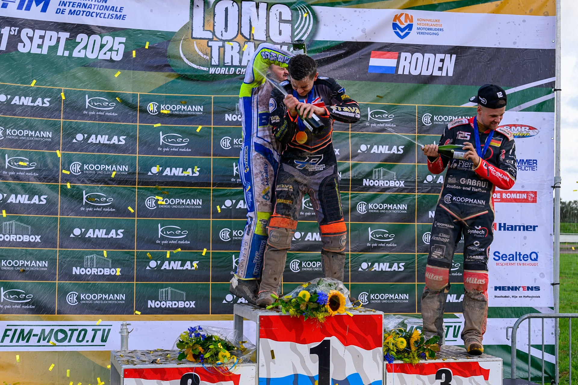 World Championships Rostrum Champagne Capers: (L to R) Chris Harris (2nd), Zach Wajtknecht (Winner), Lukas Fienhage (3rd) during the FIM Long Track World Championship Final 4, at the Speed Centre Roden, Netherlands on Sunday 21st September 2025. (Photo: Ian Charles | MI News)during the FIM Long Track World Championship Final 4, at the Speed Centre, Roden on Sunday 21st September 2025. (Photo: Ian Charles | MI News)