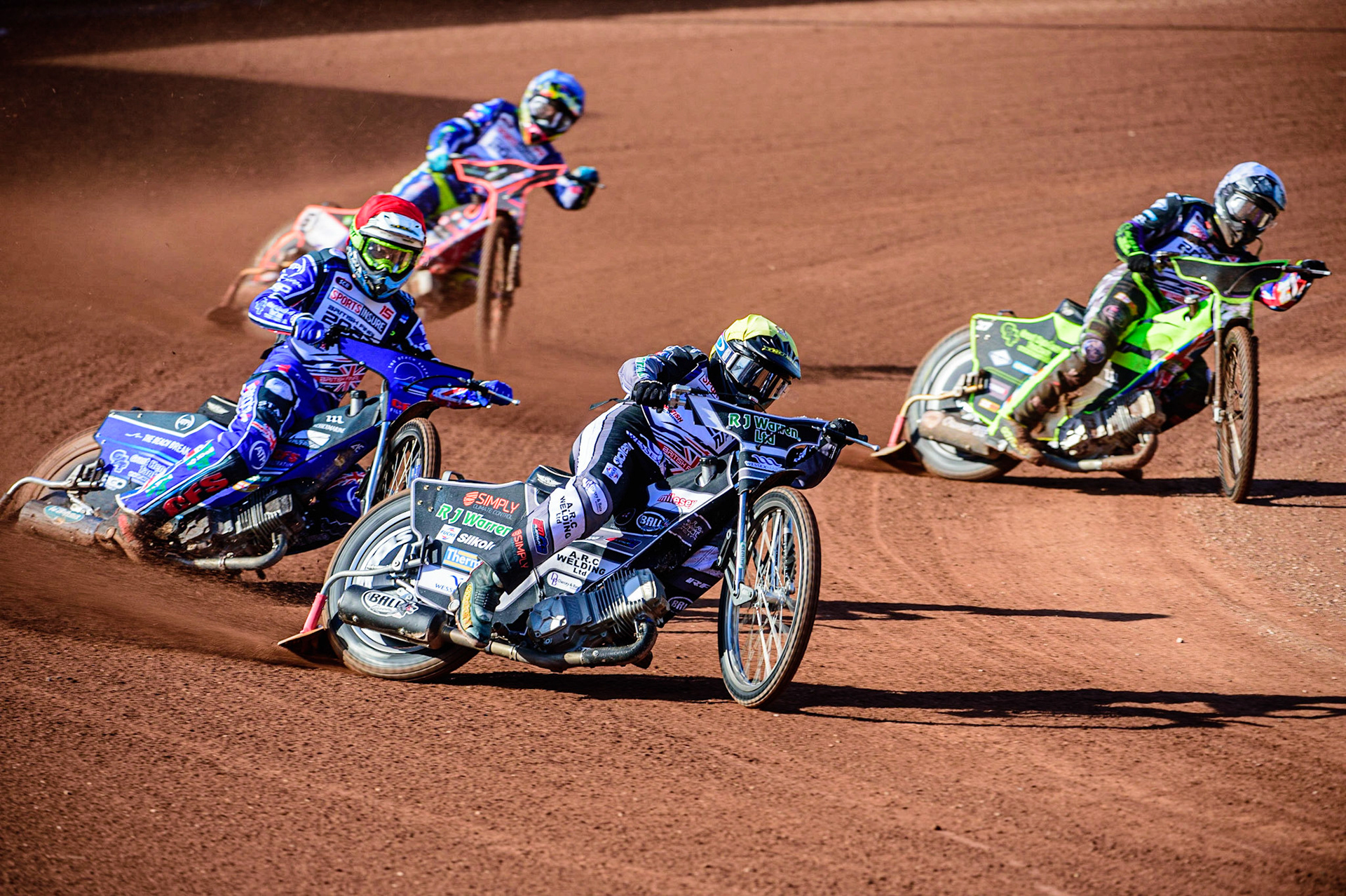 Danny King  (Yellow) leads Adam Ellis  (Red) Tom Brennan  (White) and Scott Nicholls  (Blue) during the Sports Insure British Speedway Final, at the National Speedway Stadium, Manchester, on Sunday 18th September 2022. (Credit: Ian Charles | MI News )