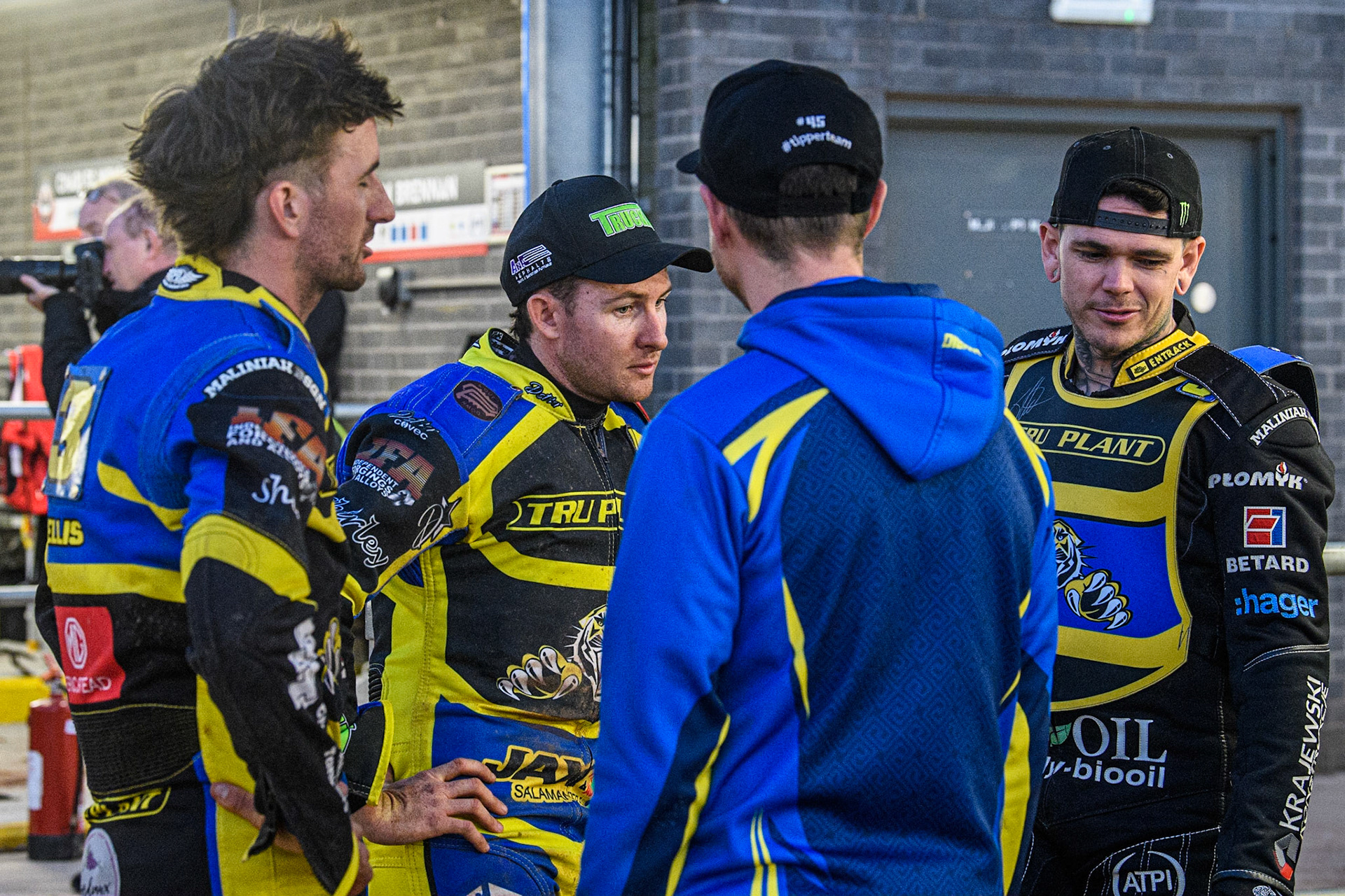 (l - r) Adam Ellis, Josh Pickering, and Tai Woffinden chat with Team Manager Simon Stead  (back to camera) during the Sports Insure Premiership match between Belle Vue Aces and Sheffield Tigers at the National Speedway Stadium, Manchester on Monday 7th August 2023. (Photo: Ian Charles | MI News)