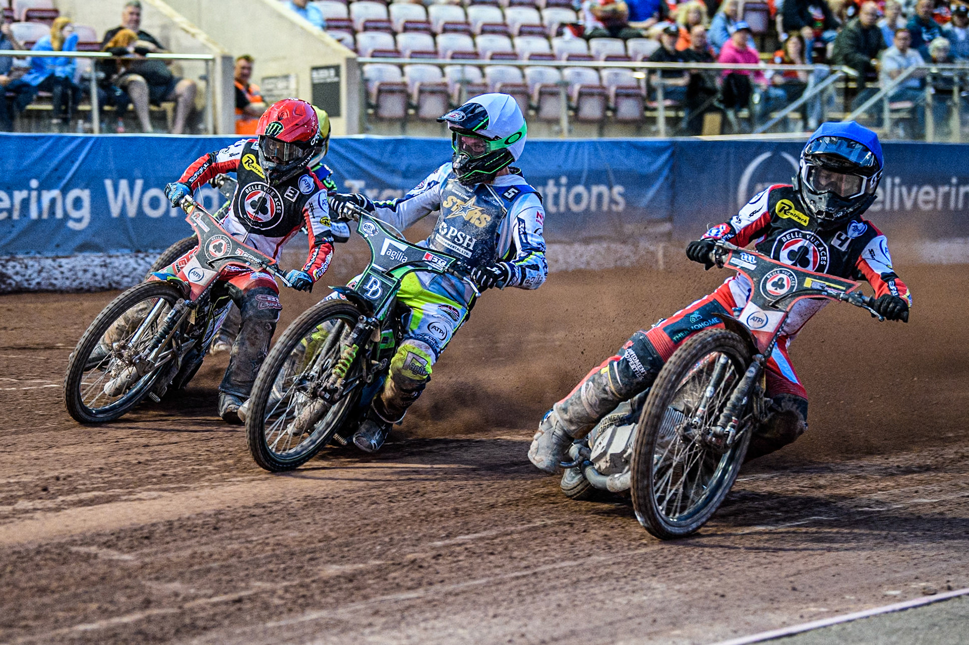 Belle Vue Aces' Ben Cook in Blue rides inside \Kings Lynn Stars' Guest Rider Charles Wright  in White, Belle Vue Aces' Jaimon Lidsey  in Red and Kings Lynn Stars' Lewis Kerr in Yellow during the Rowe Motor Oil Premiership match between Belle Vue Aces and King's Lynn Stars at the National Speedway Stadium, Manchester on Monday 12th August 2024. (Photo: Ian Charles | MI News)