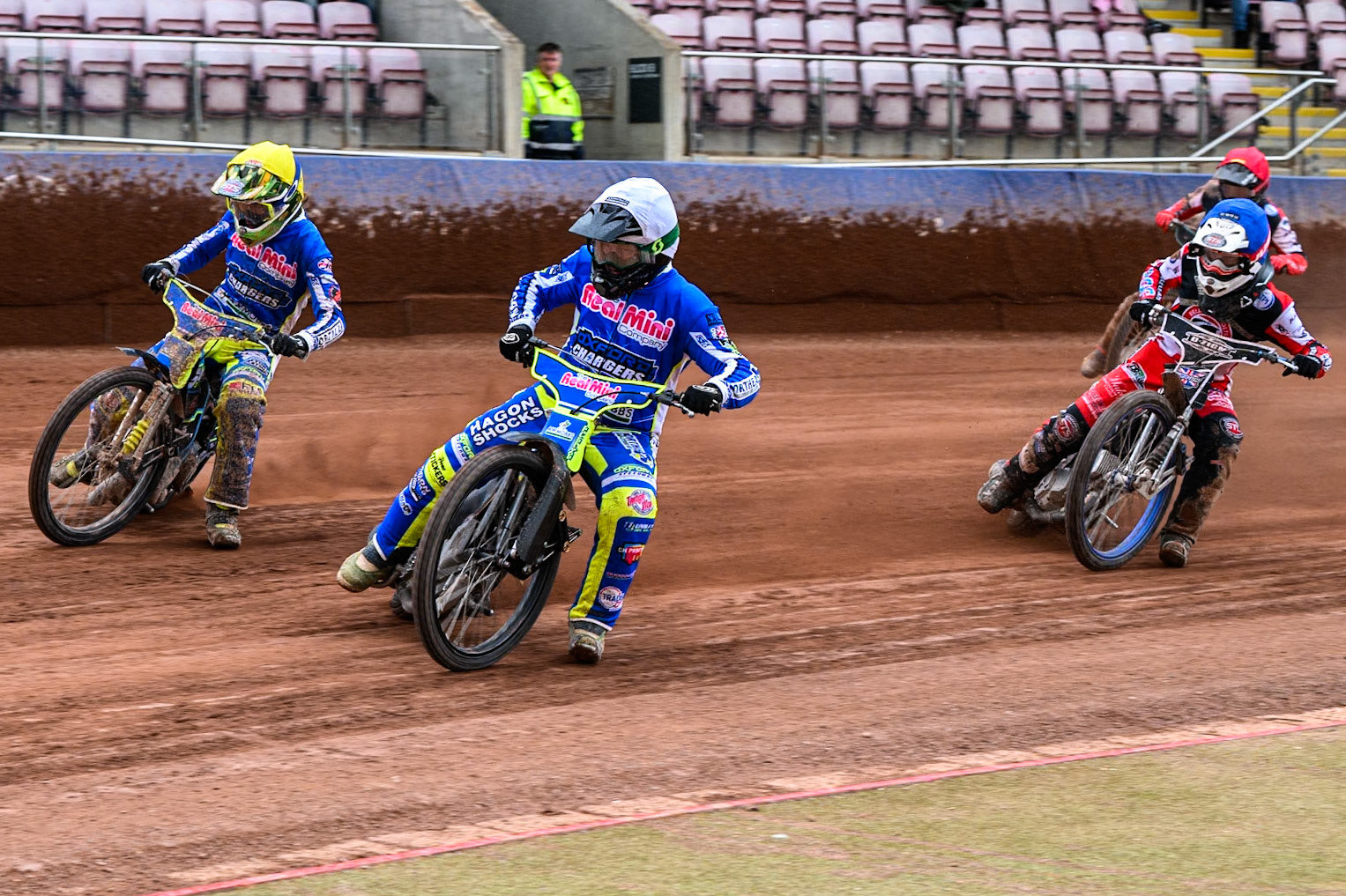 Oxford Chargers' Ashton Vale  in White rides inside Oxford Chargers' Senna Summers  in Yellow with Belle Vue Colts' Jack Shimelt in Blue and Belle Vue Colts' Mason Watson  in Red behind during the WSRA National Development League match between Belle Vue Colts and Oxford Chargers at the National Speedway Stadium, Manchester on Sunday 1st June 2025. (Photo: Ian Charles | MI News)
