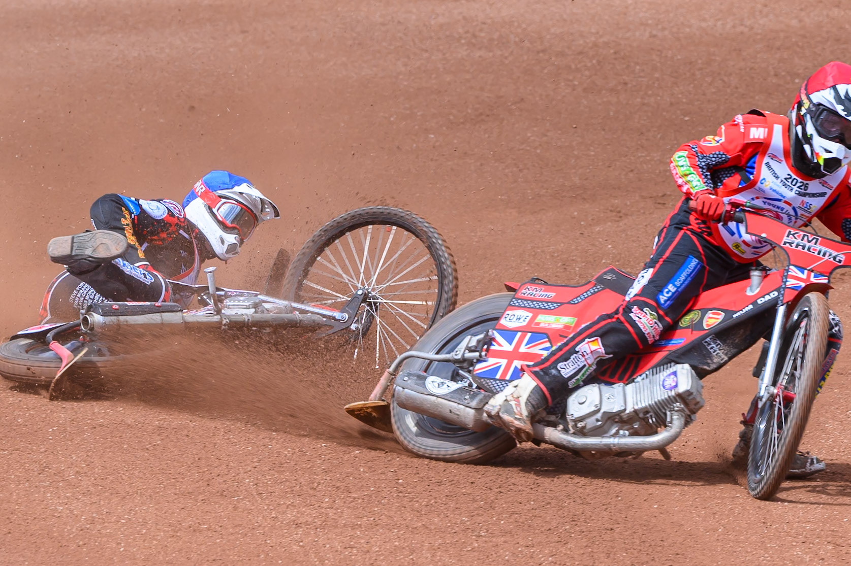 BRITISH YOUTH CHAMPIONSHIP (500cc): Kayden Mundy (8) in Red rides inside Dylan Huthwaite (9)  in Blue who then falls during the British Youth Speedway Championship at the National Speedway Stadium, Manchester on Sunday 10th May 2026. (Photo: Ian Charles | MI News)