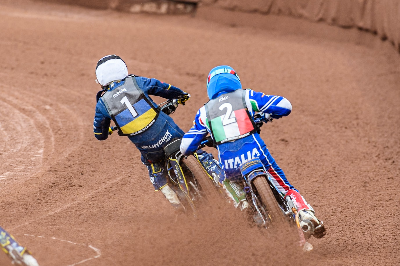 Nicolas Covatti of Italy in Blue chases Stanislav Melnychuk of Ukraine in White during the Monster Energy FIM Speedway of Nations Semi-Final 1 at the National Speedway Stadium, Manchester on Tuesday 9th July 2024. (Photo: Ian Charles | MI News)
