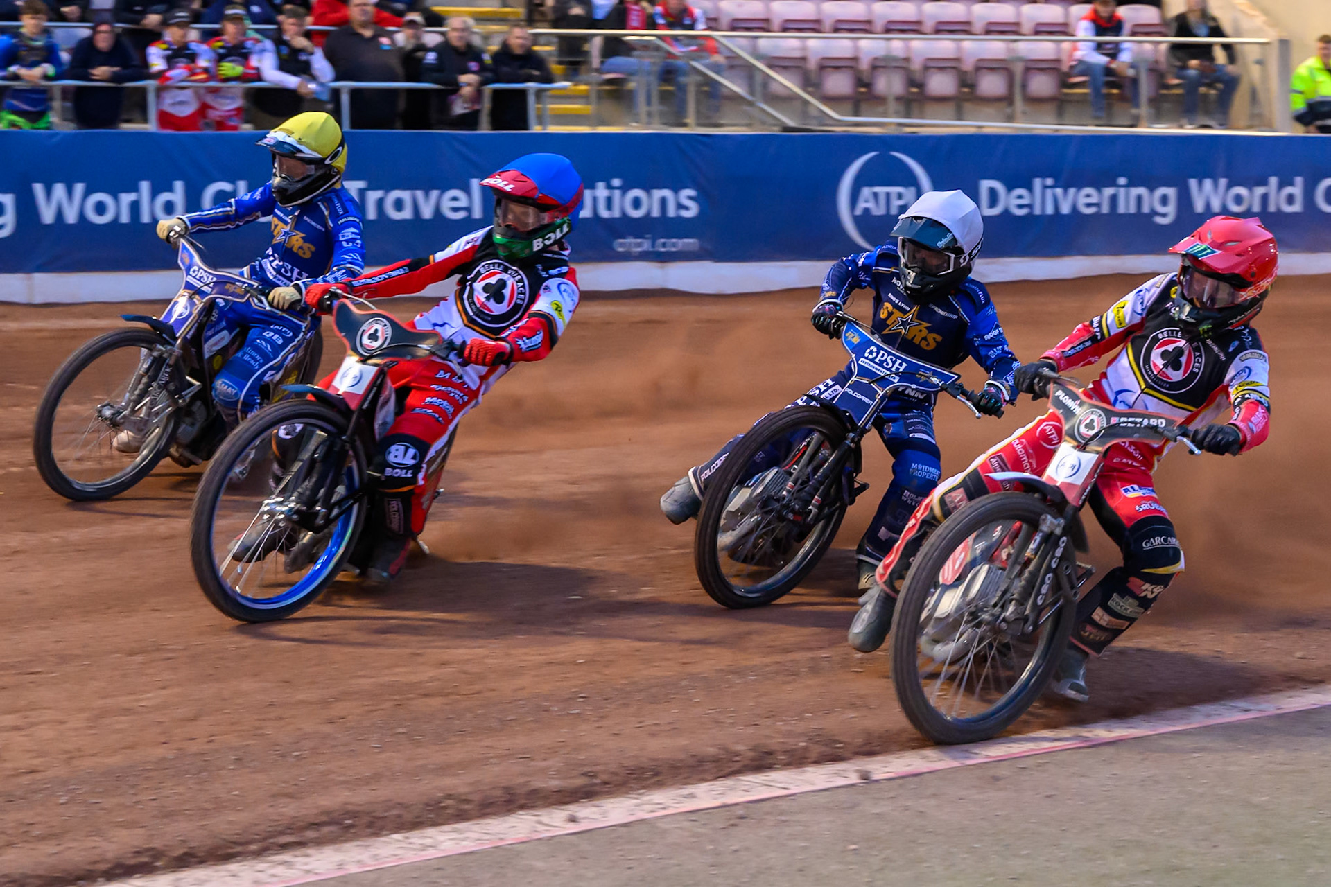 Belle Vue Aces' Dan Bewley in Red rides inside Kings Lynn Stars' Ben Cook in White, Belle Vue Aces' Brady Kurtz in Blue and Kings Lynn Stars' Nicolai Klindt in Yellow during the Rowe Motor Oil Premiership match between Belle Vue Aces and King's Lynn Stars at the National Speedway Stadium, Manchester on Monday 23rd June 2025. (Photo: Ian Charles | MI News)