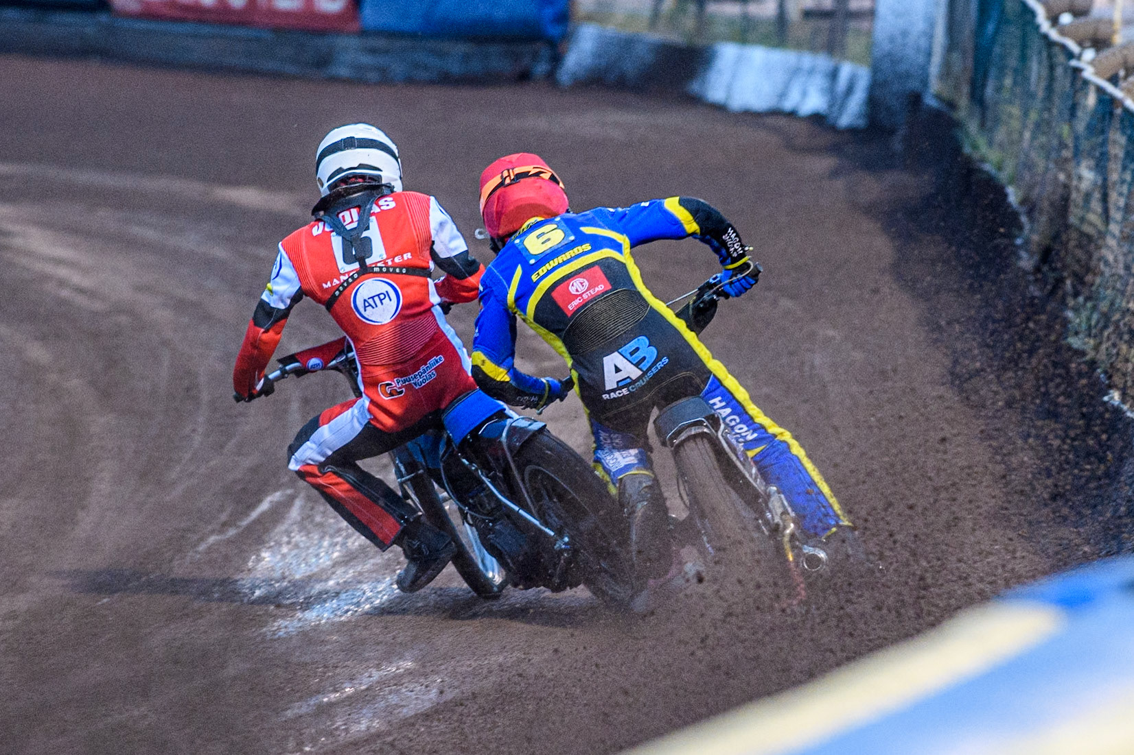Sheffield Tigers' Jason Edwards  in Red catches his leg on the rear tyre of Belle Vue Aces' Antti Vuolas in White during the Rowe Motor Oil Premiership match between Sheffield Tigers and Belle Vue Aces at Owlerton Stadium, Sheffield on Monday 26th August 2024. (Photo: Ian Charles | MI News)