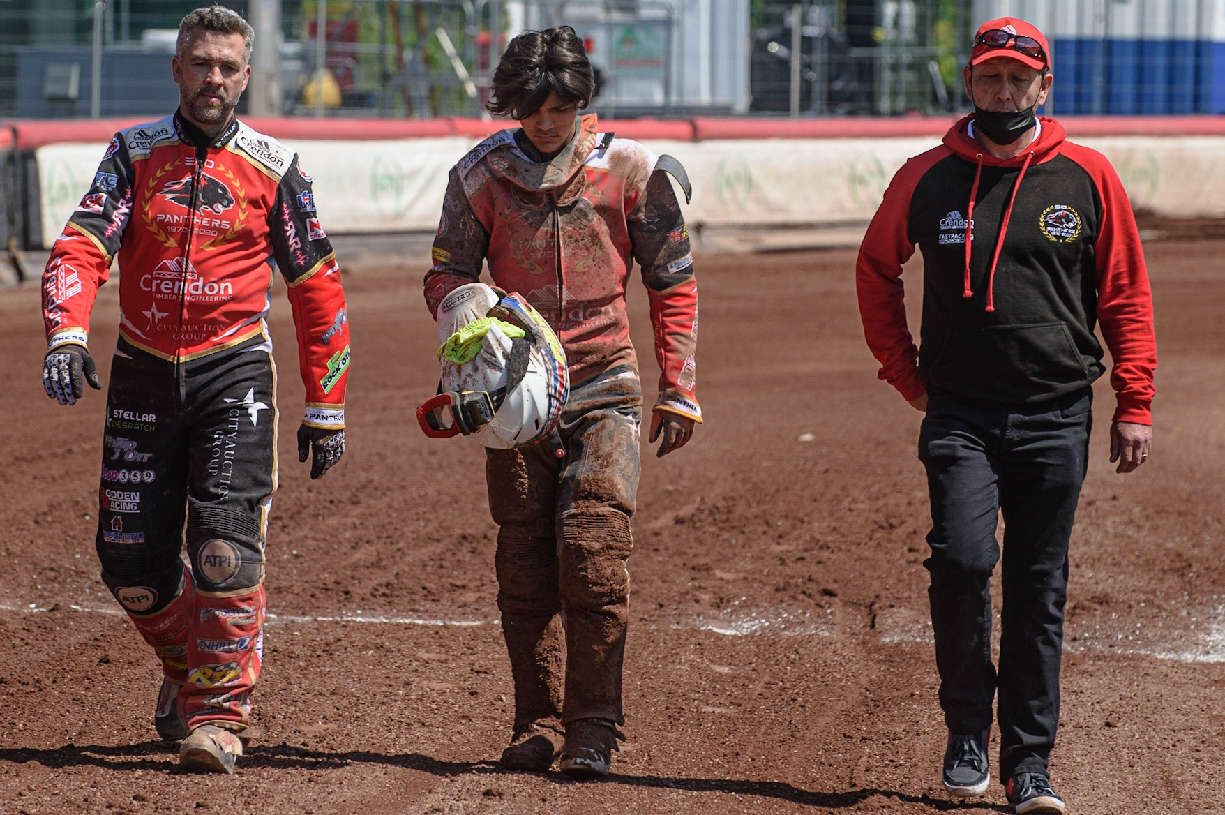 MANCHESTER, UK. MAY 31ST  Peterborough Crendon Panthers skipper Scott Nicholls  (left) and Team Manager Rob Lyon (right) walk back to the pits with Jordan Palin  after his crash during the SGB Premiership match between Belle Vue Aces and Peterborough at the National Speedway Stadium, Manchester on Monday 31st May 2021. (Credit: Ian Charles | MI News)