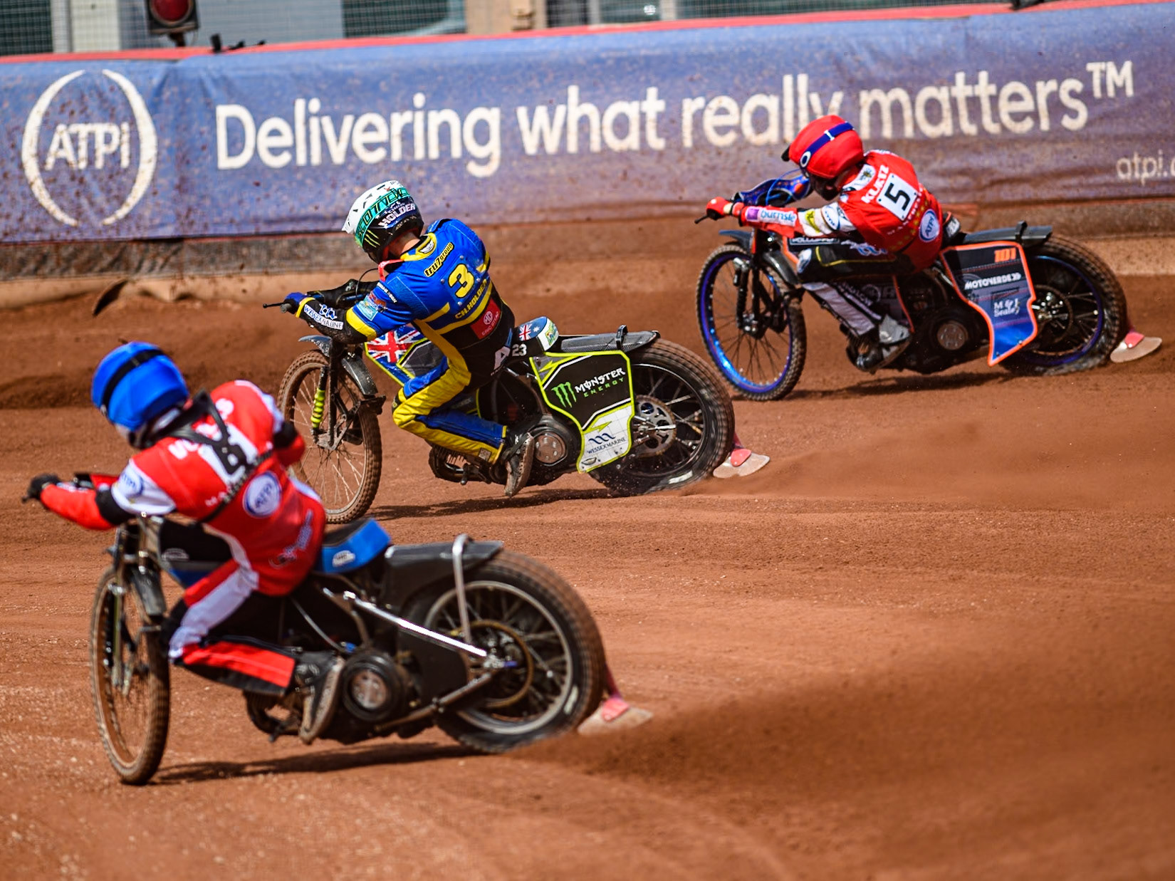 Sheffield Tigers' Chris Holder  in White rides inside Belle Vue Aces' Brady Kurtz  in Red with Belle Vue Aces' Antti Vuolas  in Blue chasing during the Rowe Motor Oil Premiership match between Belle Vue Aces and Sheffield Tigers at the National Speedway Stadium, Manchester on Monday 26th August 2024. (Photo: Ian Charles | MI News)
