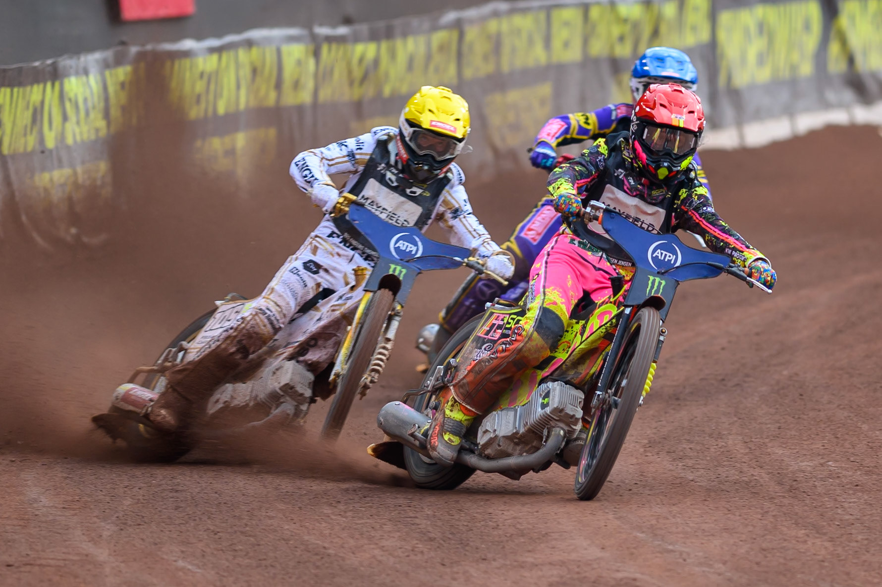 Michael Jepsen Jensen (52) of Denmark in Red leading Anders Thomsen (105) of Denmark in Yellow and Kacper Woryna (223) of Poland in Blue during the ATPI  FIM Speedway GP of Manchester at the National Speedway Stadium, Manchester on Saturday 6th June 2026. (Photo: Ian Charles | MI News)