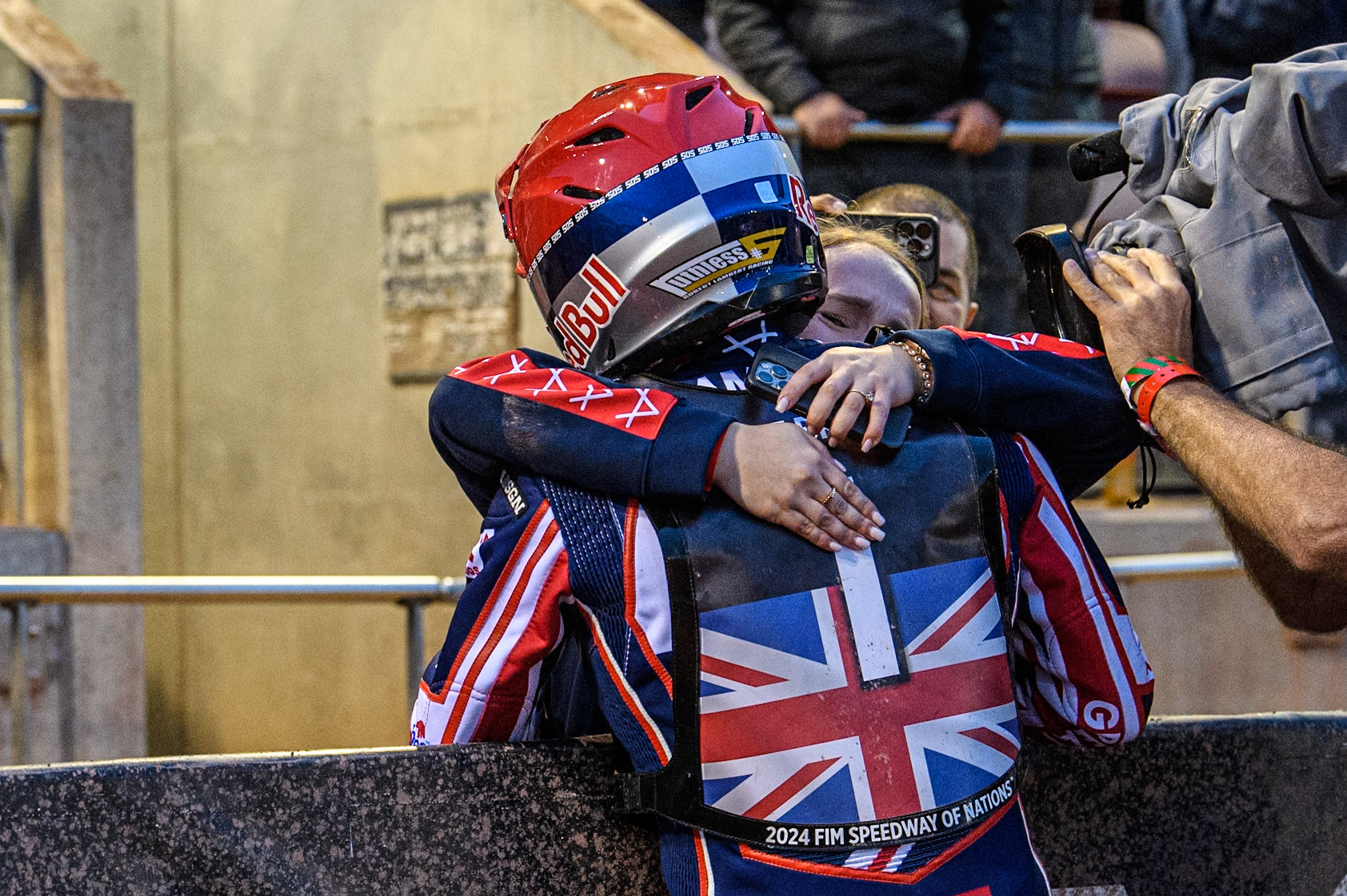 Robert Lambert of Great Britain embraces his girlfriend after the Team GB win during the Monster Energy FIM Speedway of Nation Final at the National Speedway Stadium, Manchester on Saturday 13th July 2024. (Photo: Ian Charles | MI News)