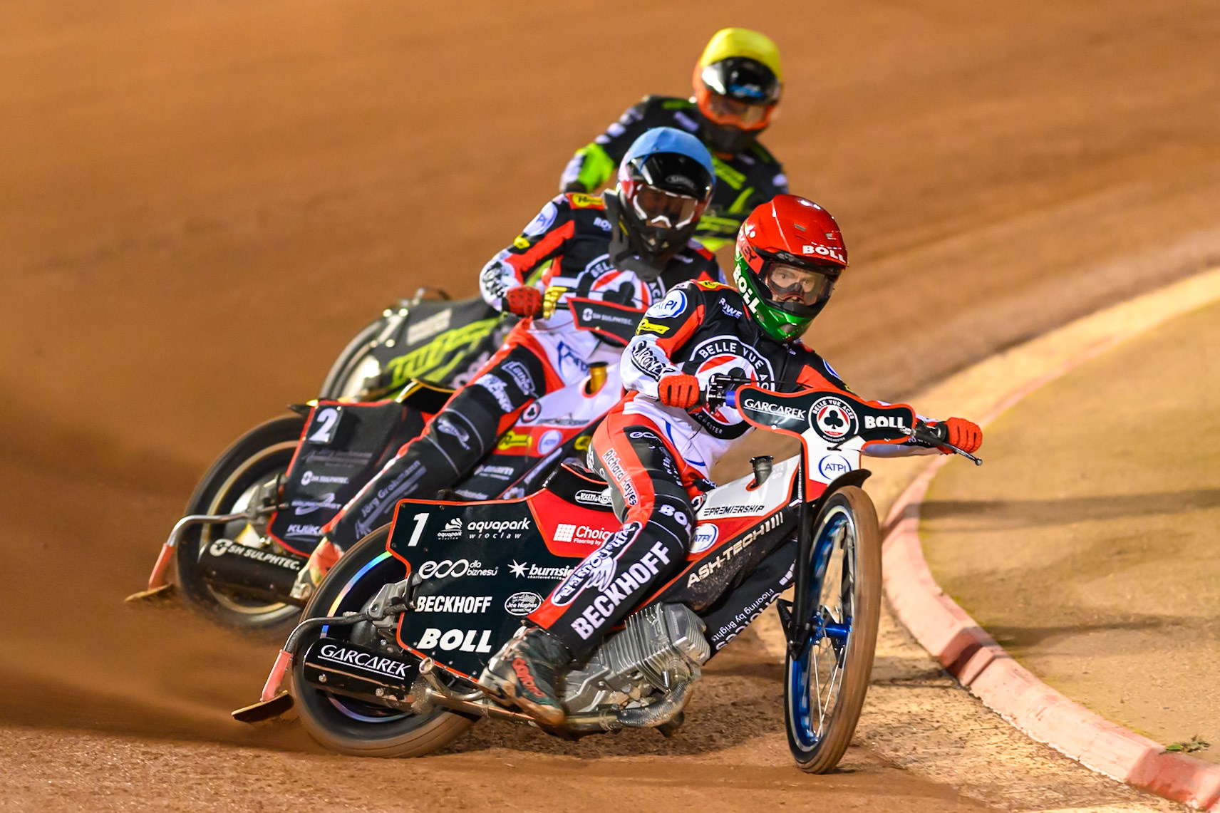 Brady Kurtz of Belle Vue Aces in Red leading Norick Blödorn of Belle Vue Aces in Blue  and Jason Edwards of Ipswich Witches in Yellow during the Rowe Motor Oil Premiership Play Off Semi Final 2nd leg match between Belle Vue Aces and Ipswich Witches at the National Speedway Stadium, Manchester on Monday 28th September 2026. (Photo: Ian Charles | MI News)