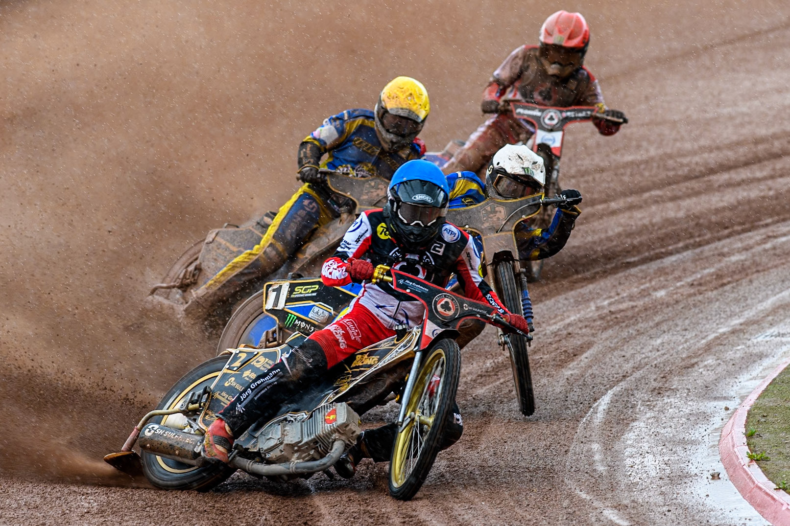 Belle Vue Aces' Norick Blodorn  in Blue leading Sheffield Tigers' Jack Holder in White, Sheffield Tigers' Kyle Howarth in Yellow and Belle Vue Aces' Dan Bewley in Red during the Rowe Motor Oil Premiership match between Belle Vue Aces and Sheffield Tigers at the National Speedway Stadium, Manchester on Monday 27th May 2024. (Photo: Ian Charles | MI News)