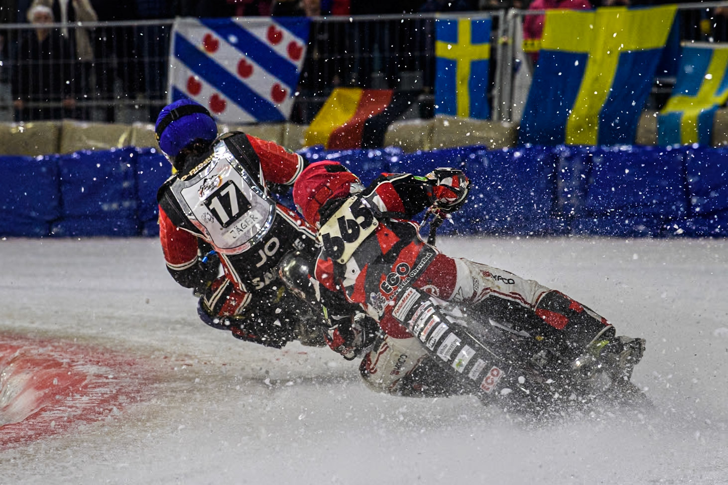 Austria's Charly Ebner (665) in Red chases Reserve  Sweden's Filip Jäger (17) in Blue during the FIM Ice Speedway Gladiators World Championship Final 3 at Ice Rink Thialf, Heerenveen on Saturday 6th April 2024. (Photo: Ian Charles | MI News)