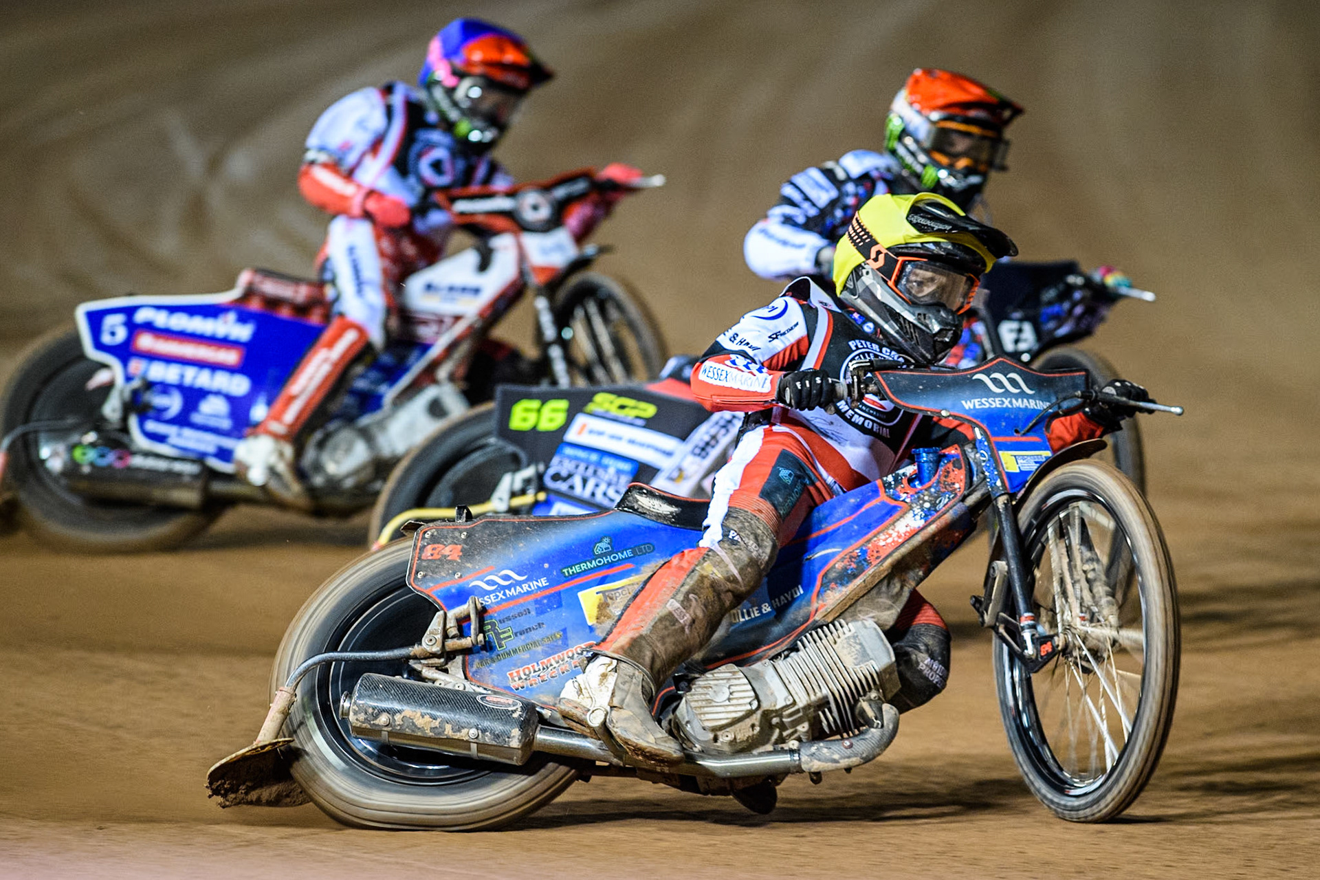 Australia's Ben Cook (Yellow) leads  Sweden's Fredrik Lindgren (Red) and England's Dan Bewley (Blue) during the Peter Craven Memorial Trophy meeting at the National Speedway Stadium, Manchester on Monday 18th March 2024. (Photo: Ian Charles | MI News)