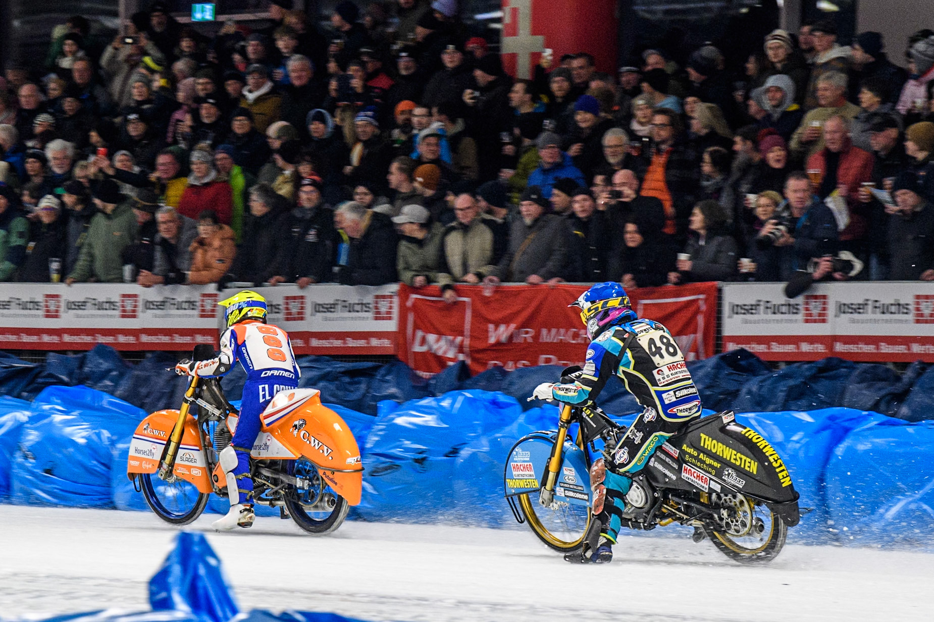 Luca Bauer (48) of Germany in Blue chases Jasper Iwema (800) of The Netherlands in Yellow during the Ice Speedway Gladiators World Championship Final 1 at Max-Aicher-Arena, Inzell on Saturday 15th March 2025. (Photo: Ian Charles | MI News)