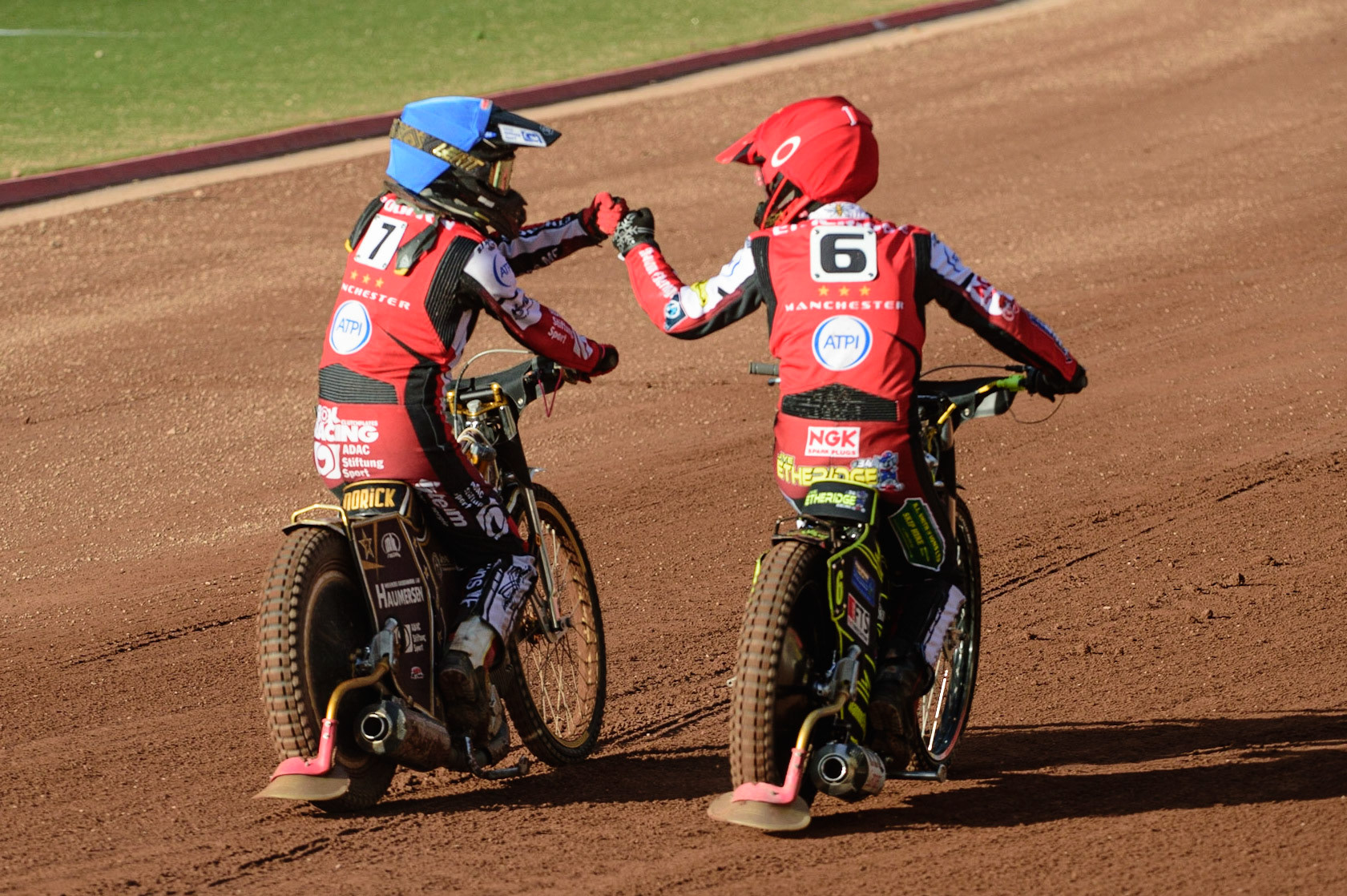 MANCHESTER, UK. JUL 5TH  Norick Blodorn  (Blue) and Jye Etheridge  (Red) celebrate their maximum heat win  during the SGB Premiership match between Belle Vue Aces and Sheffield Tigers at the National Speedway Stadium, Manchester on Tuesday 5th July 2022. (Credit: Ian Charles | MI News)