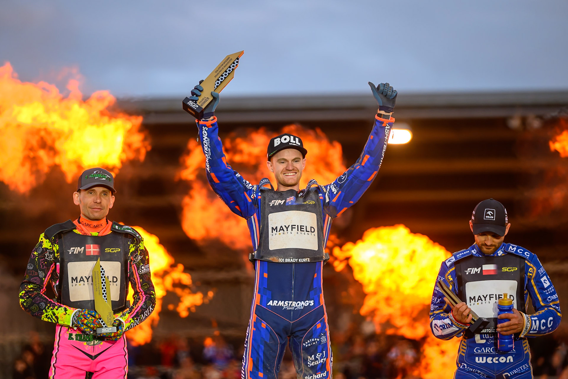 Brady Kurtz (101) of Australia (Centre) celebrates his win in the Final with Michael Jepsen Jensen (52) of Denmark (Left) and Bartosz Zmarzlik (95) of Poland (Right) during the ATPI  FIM Speedway GP of Manchester at the National Speedway Stadium, Manchester on Saturday 6th June 2026. (Photo: Ian Charles | MI News)