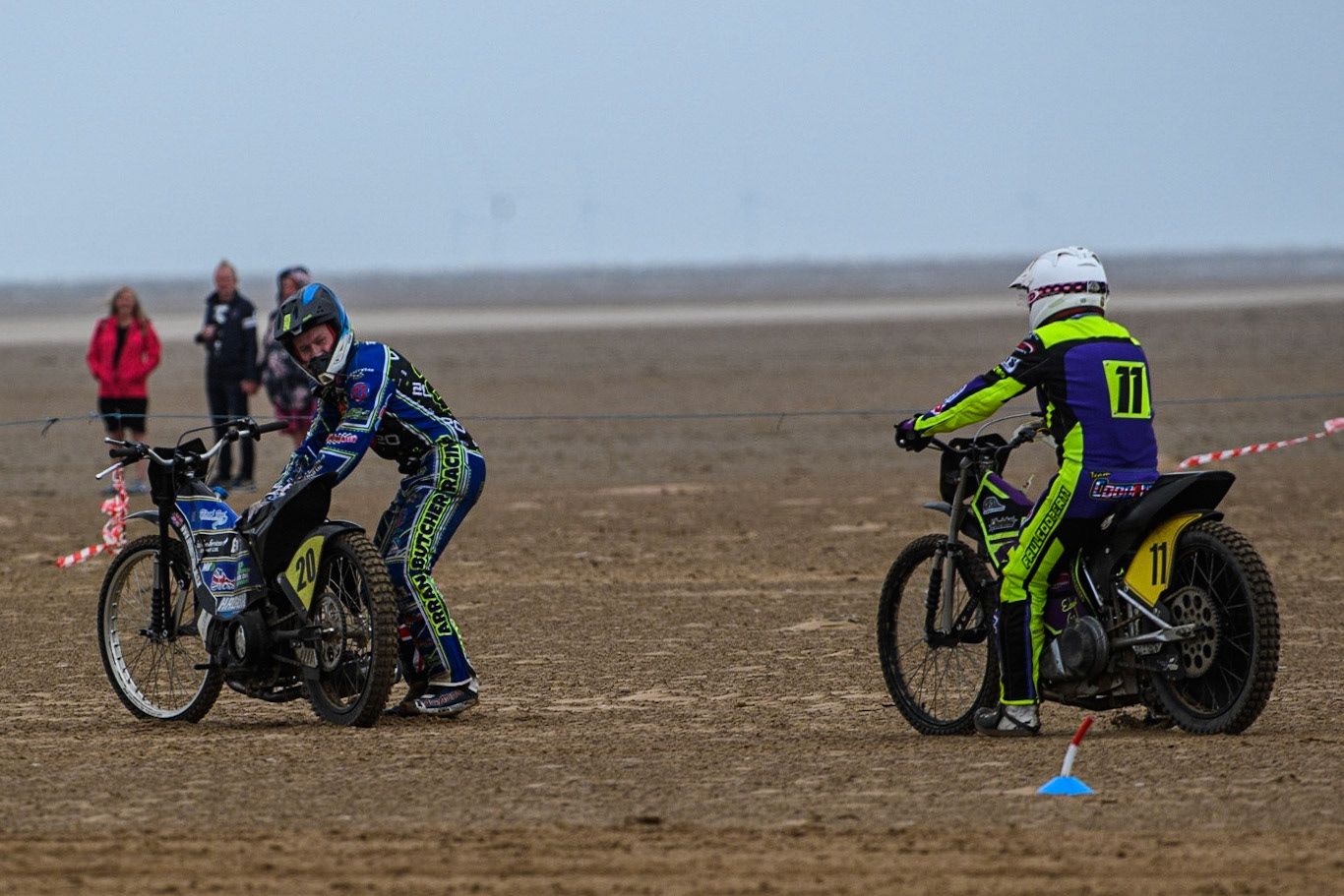 Paul Cooper (11) rides over to Arran Butcher (20) after he broke down in the final whilst leading during the Fylde ACU British Sand Racing Masters Championship at  St Annes on Sea, Lancashire on Sunday 30th July 2023. (Photo: Ian Charles | MI News)