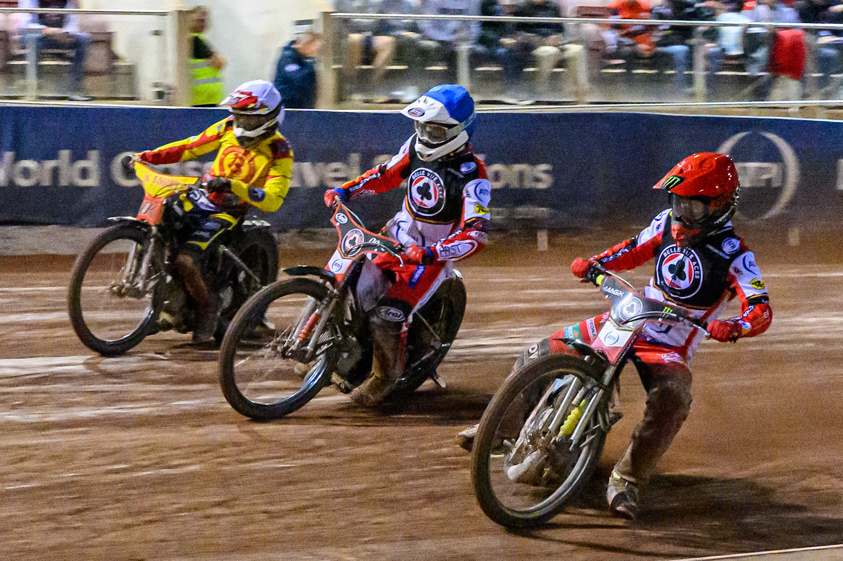 Jaimon Lidsey of Belle Vue Aces  in Red rides inside Jake Mulford of Belle Vue Aces in Blue and Keynan Rew of Birmingham Brummies  in White during the Rowe Motor Oil Premiership match between Belle Vue Aces and Birmingham Brummies at the National Speedway Stadium, Manchester on Monday 18th August 2025. (Photo: Ian Charles | MI News)