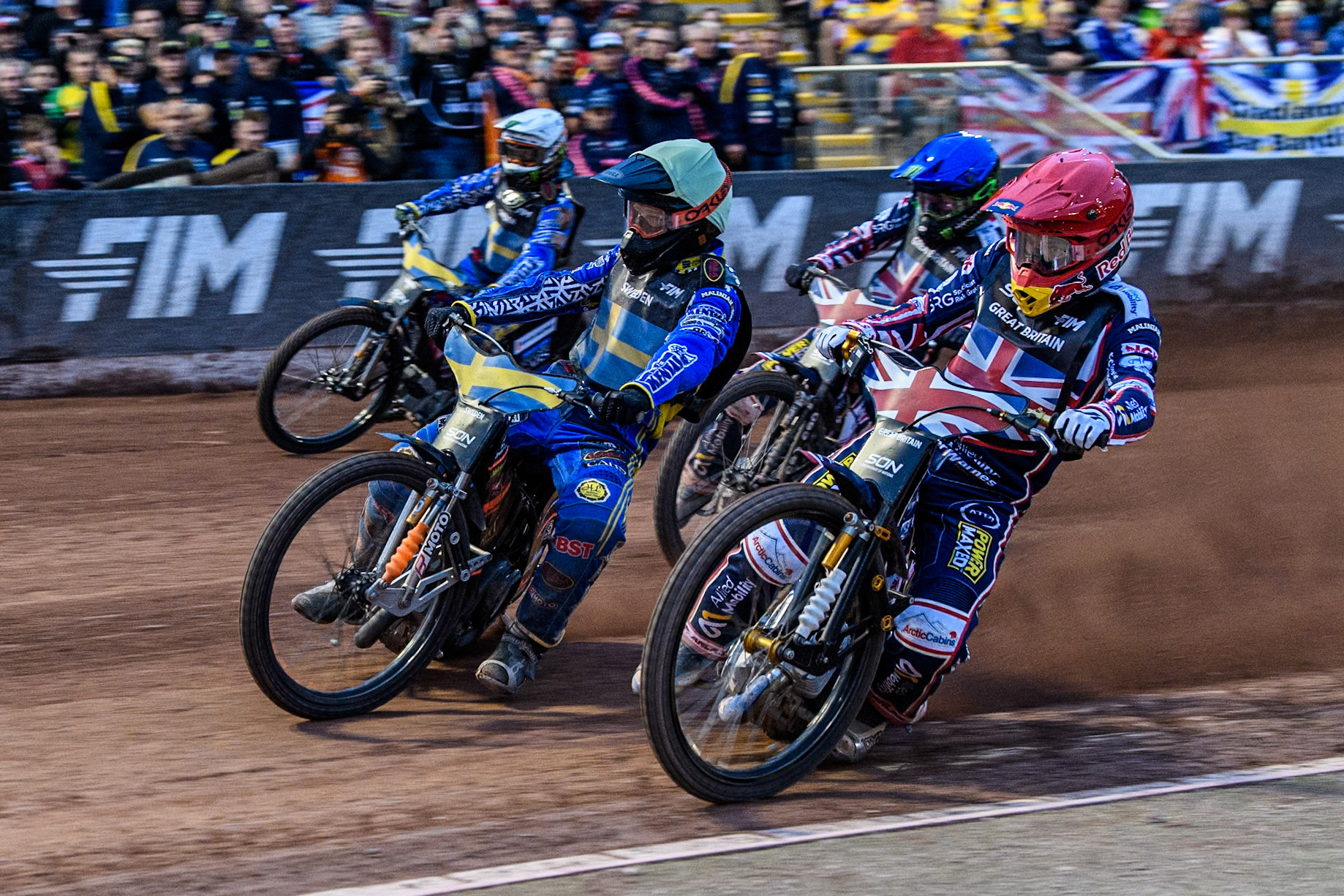 SEMI FINAL; GREAT BRITAIN v SWEDEN Robert Lambert of Great Britain in Red rides inside Jacob Thorssell of Sweden in Yellow with Dan Bewley of Great Britain in Blue and Fredrik Lindgren of Sweden in White behind during the Monster Energy FIM Speedway of Nation Final at the National Speedway Stadium, Manchester on Saturday 13th July 2024. (Photo: Ian Charles | MI News)