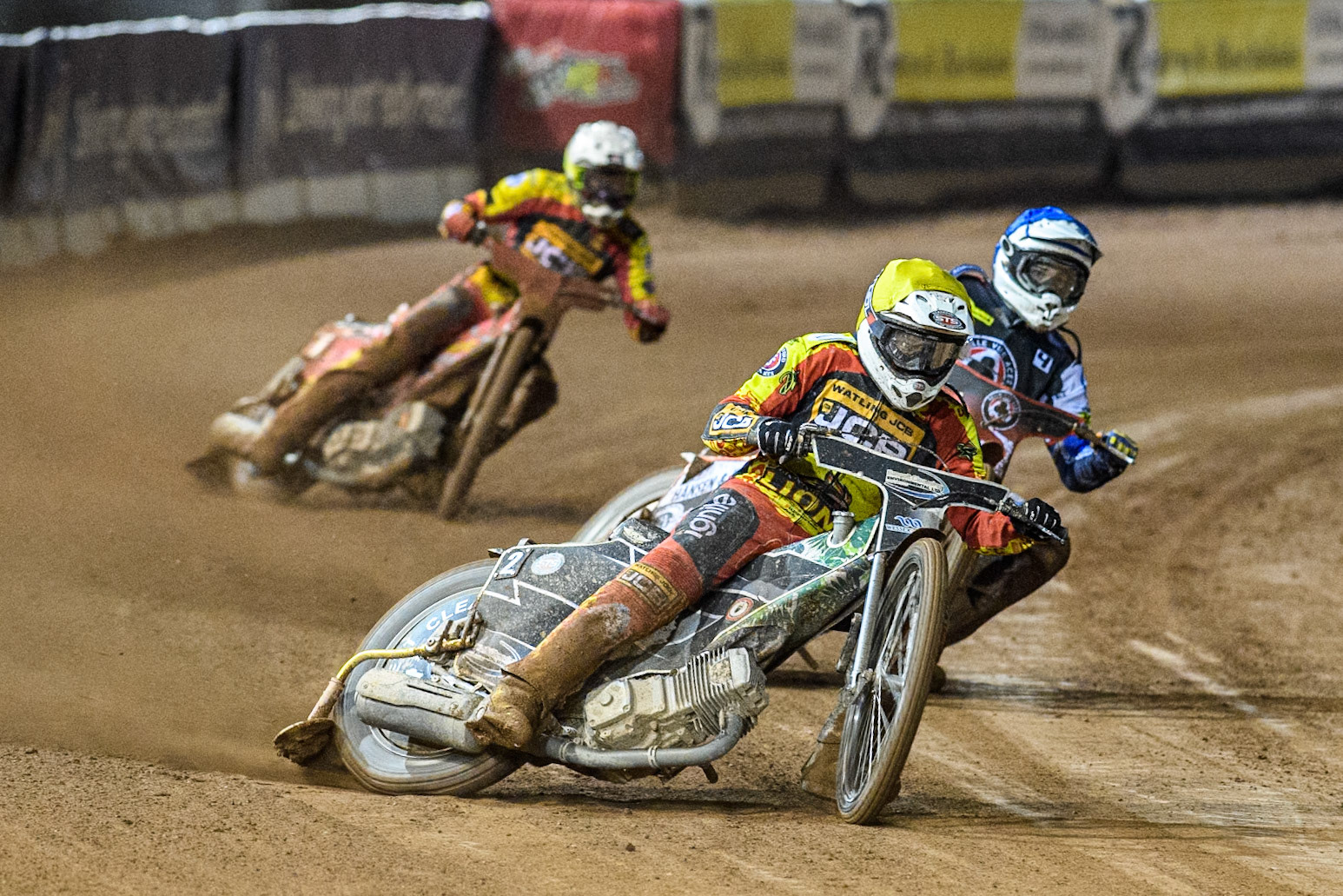 Leicester Lions' Richard Lawson  in Yellow leading Belle Vue Aces' Guest Rider Niels. K. Iversen  in Blue and Leicester Lions' Max Fricke  in White during the Rowe Motor Oil Premiership Grand Final 1st Leg between Belle Vue Aces and Leicester Lions at the National Speedway Stadium, Manchester on Monday 23rd September 2024. (Photo: Ian Charles | MI News)