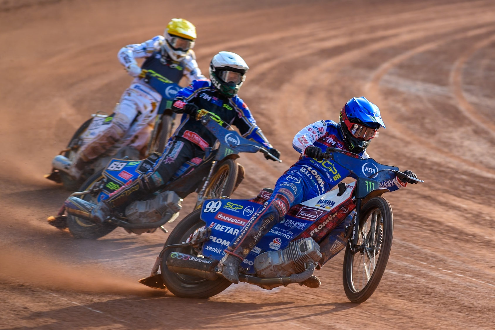 Dan Bewley (99) of Great Britain in Blue leading Jason Doyle (69) of Australia in White and Anders Thomsen (105) of Denmark in Yellow during the ATPI FIM Speedway Grand Prix Round 5 at the National Speedway Stadium, Manchester, on Saturday 14th June 2025. (Photo: Ian Charles | MI News)