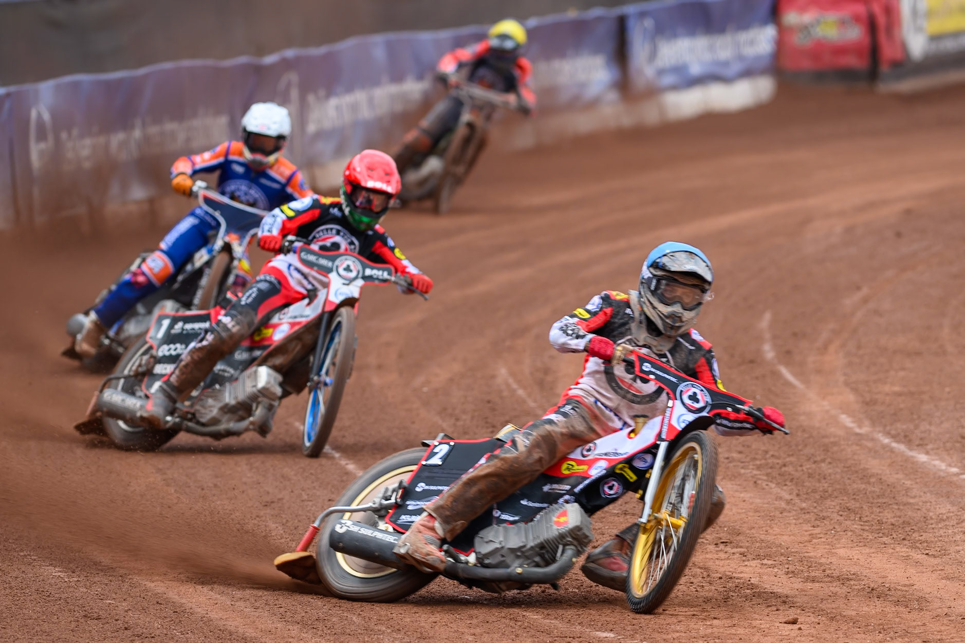 Norick Blödorn of Belle Vue Aces in Blue and team mate Brady Kurtz of Belle Vue Aces in Red leading Nicolai Klindt of Northampton Foxes in White and Kye Thomson of Northampton Foxes in Yellow during the Rowe Motor Oil Premiership match between Belle Vue Aces and Northampton Foxes at the National Speedway Stadium, Manchester on Monday 4th May 2026. (Photo: Ian Charles | MI News)