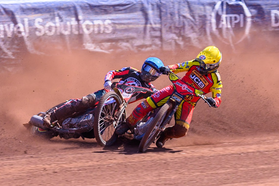 Kyle Howarth of Leicester Lions  in Yellow brings down Tate Zischke of Belle Vue Aces in Blue during the Knockout Cup Northern Section match between Belle Vue Aces and Leicester Lions at the National Speedway Stadium, Manchester on Monday 6th April 2026. (Photo: Ian Charles | MI News)