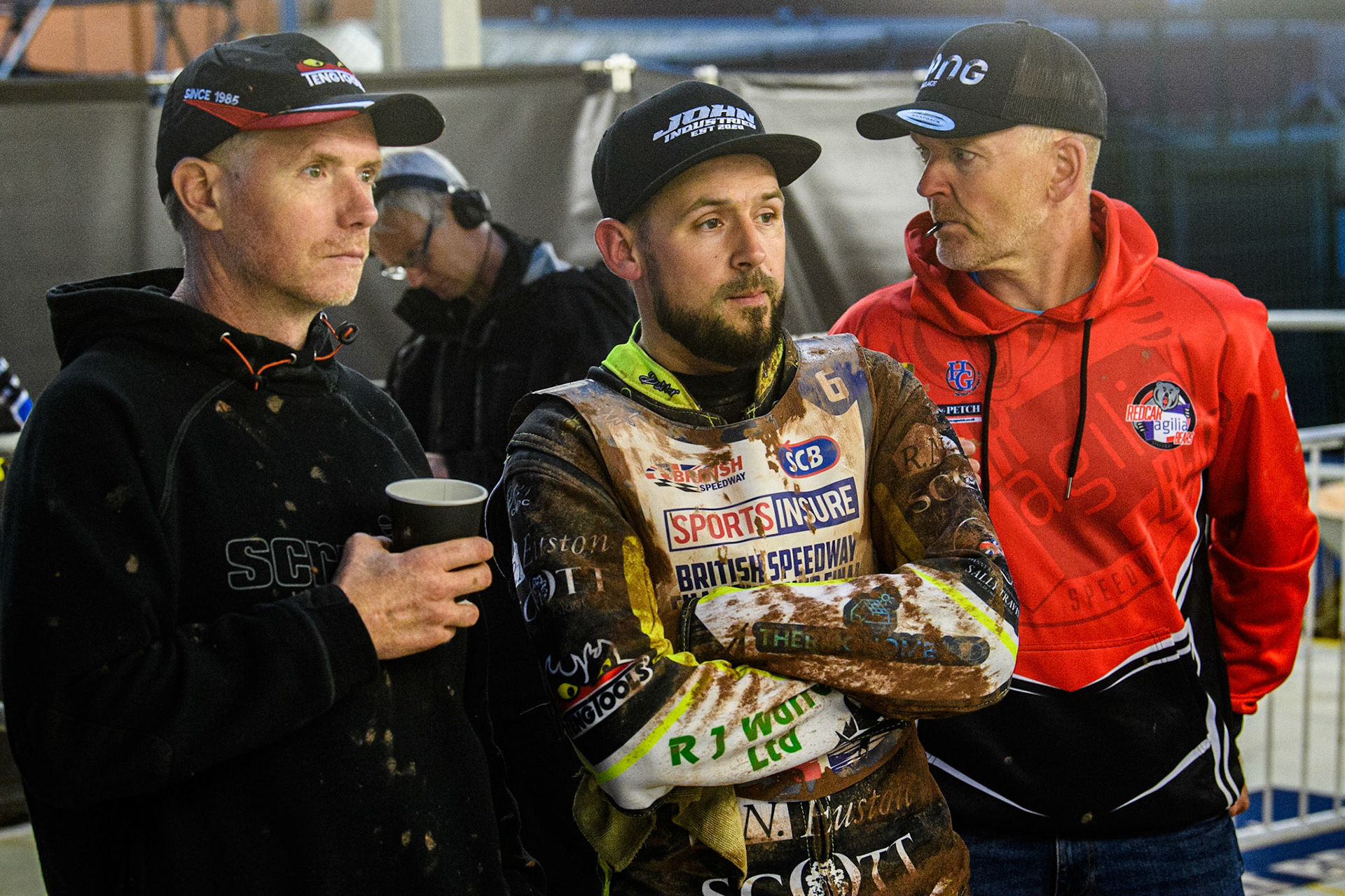 Danny King (centre) and his mechanic (left) watch the TV Monitor during the Sports Insure British Speedway Final at the National Speedway Stadium, Manchester on Monday 14th August 2023. (Photo: Ian Charles | MI News)