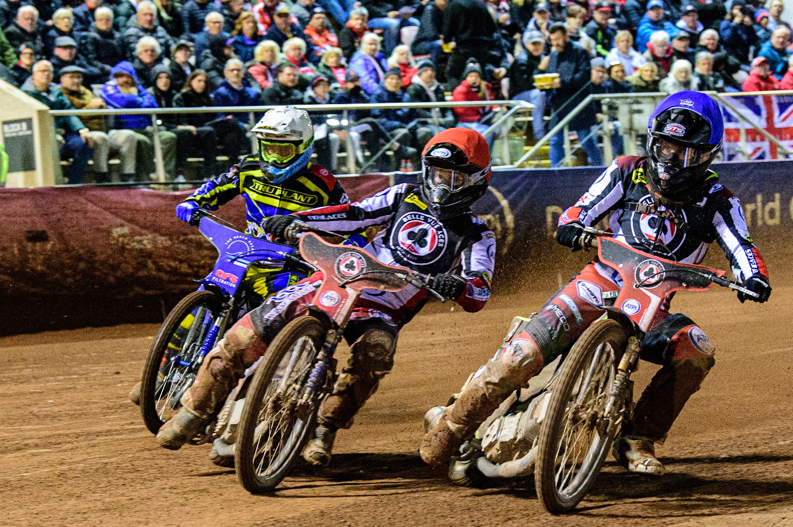 Brady Kurtz  (Red) and Tom Brennan  (Blue) go for maximum heat points ahead of Adam Ellis  (White) during the SGB Premiership Grand Final 1st leg between Belle Vue Aces and Sheffield Tigers at the National Speedway Stadium, Manchester on Monday 10th October 2022. (Credit: Ian Charles | MI News)